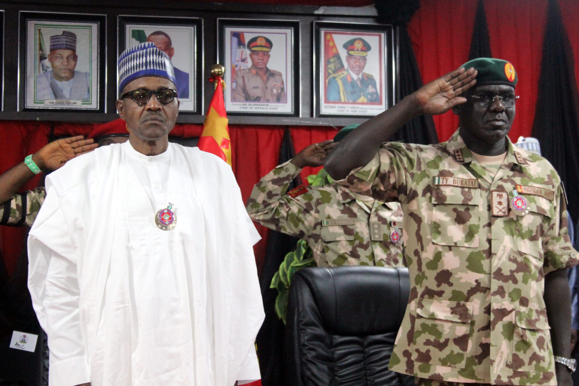 <p>Nigerian president Muhammadu Buhari stands next to Chief of Army Staff Tukur Yusuf Buratai during the opening ceremony of the military staff annual conference, on November 28, 2018, during his trip to visit troops fighting Boko Haram.</p>