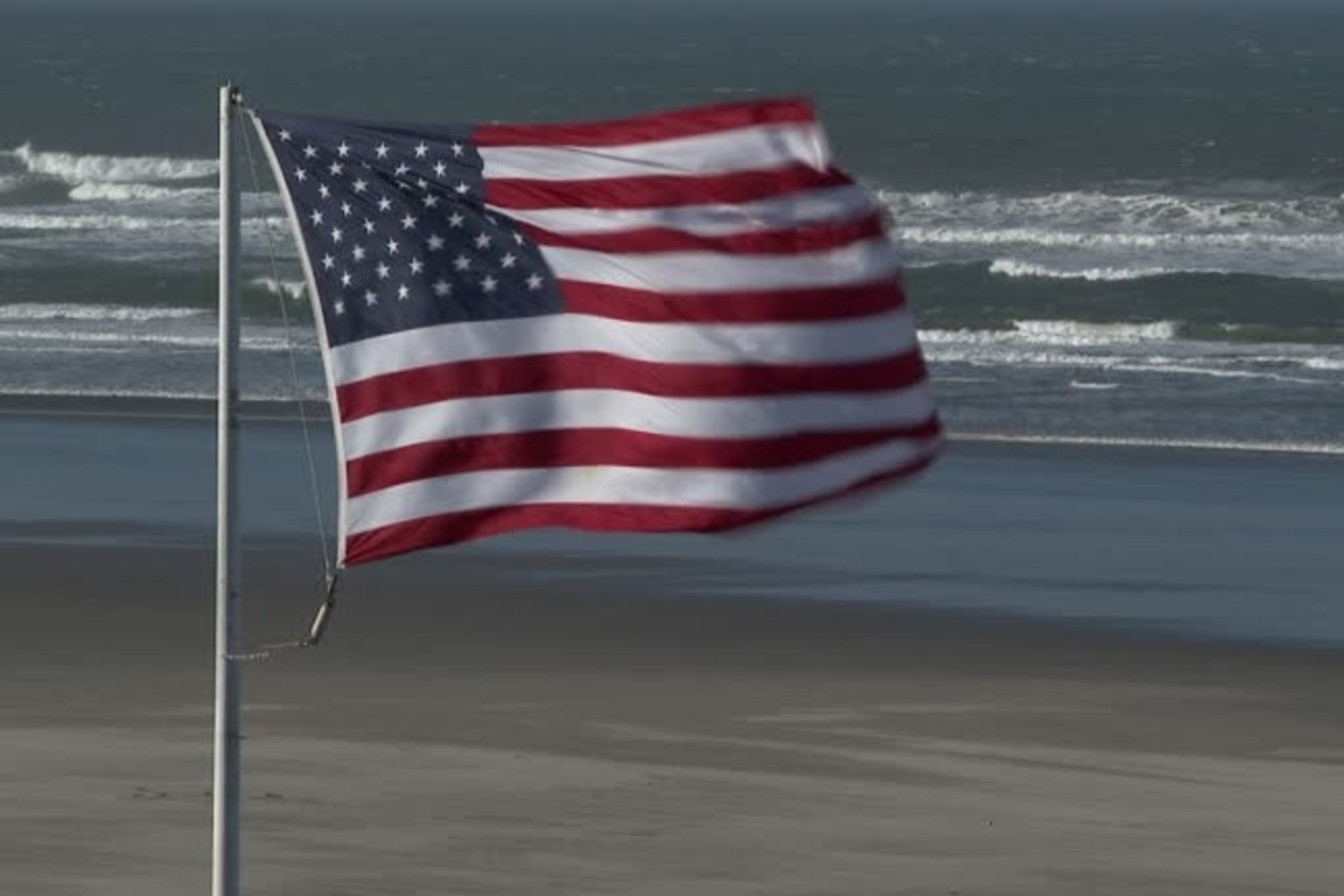 <p>An American flag flies on the edge of the Atlantic ocean. </p>

