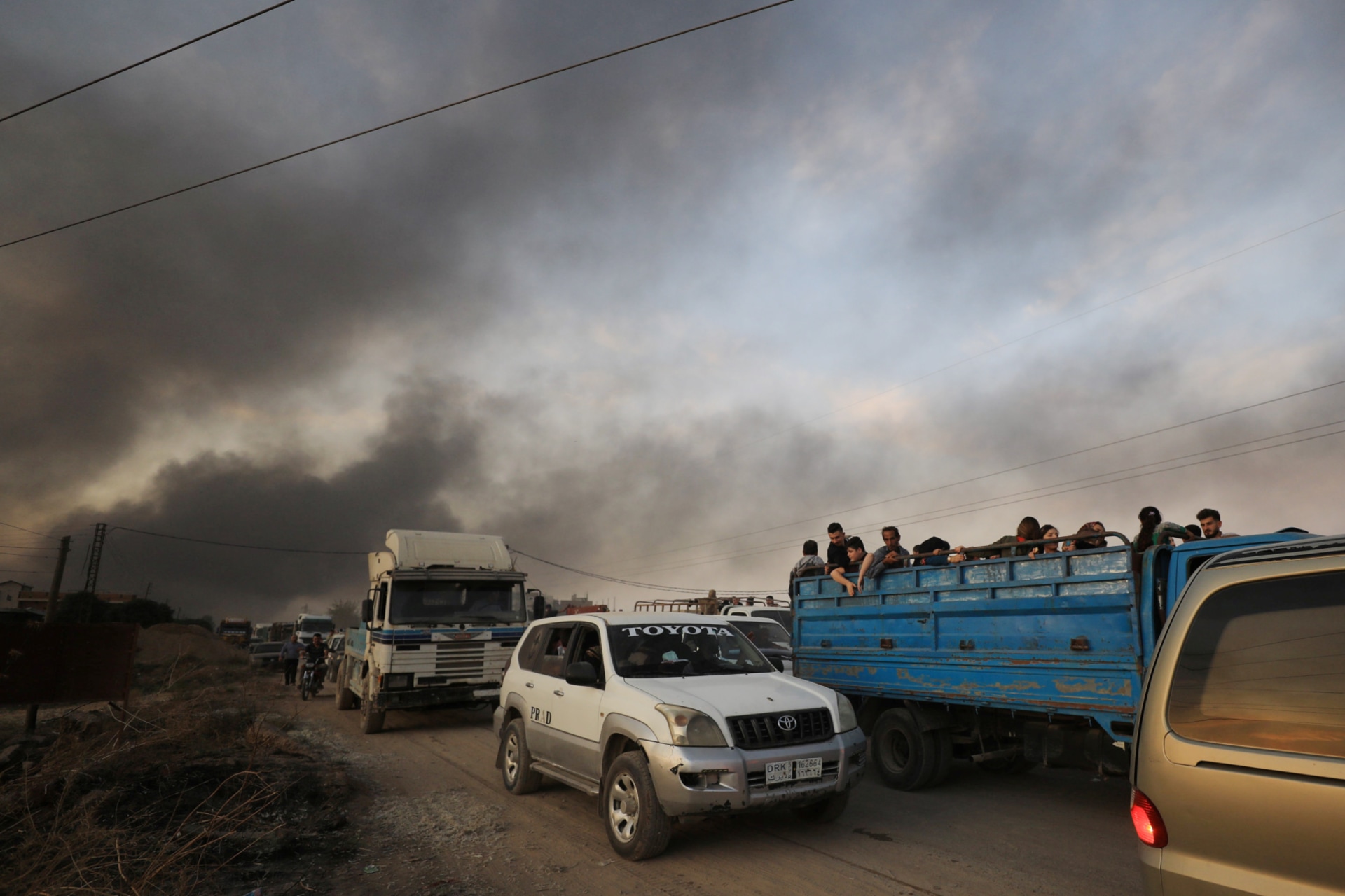 <p>People flee Turkish airstrikes in the Kurdish-held border town of Ras al Ain on October 9.</p>
