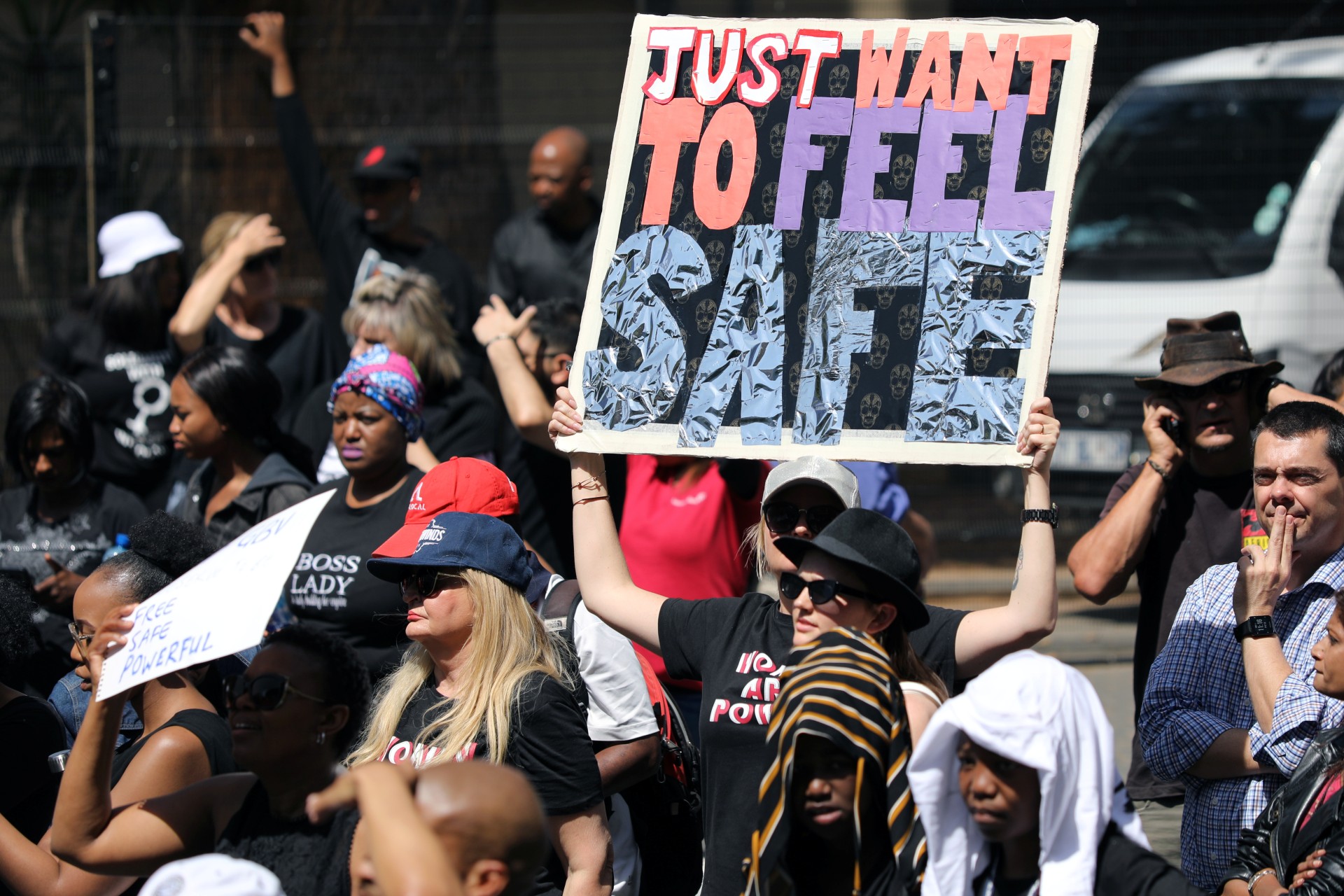 <p>Demonstrators hold placards as they protest against gender-based violence, outside the Johannesburg Stock Exchange in Sandton, Johannesburg, South Africa, on September 13, 2019.</p>