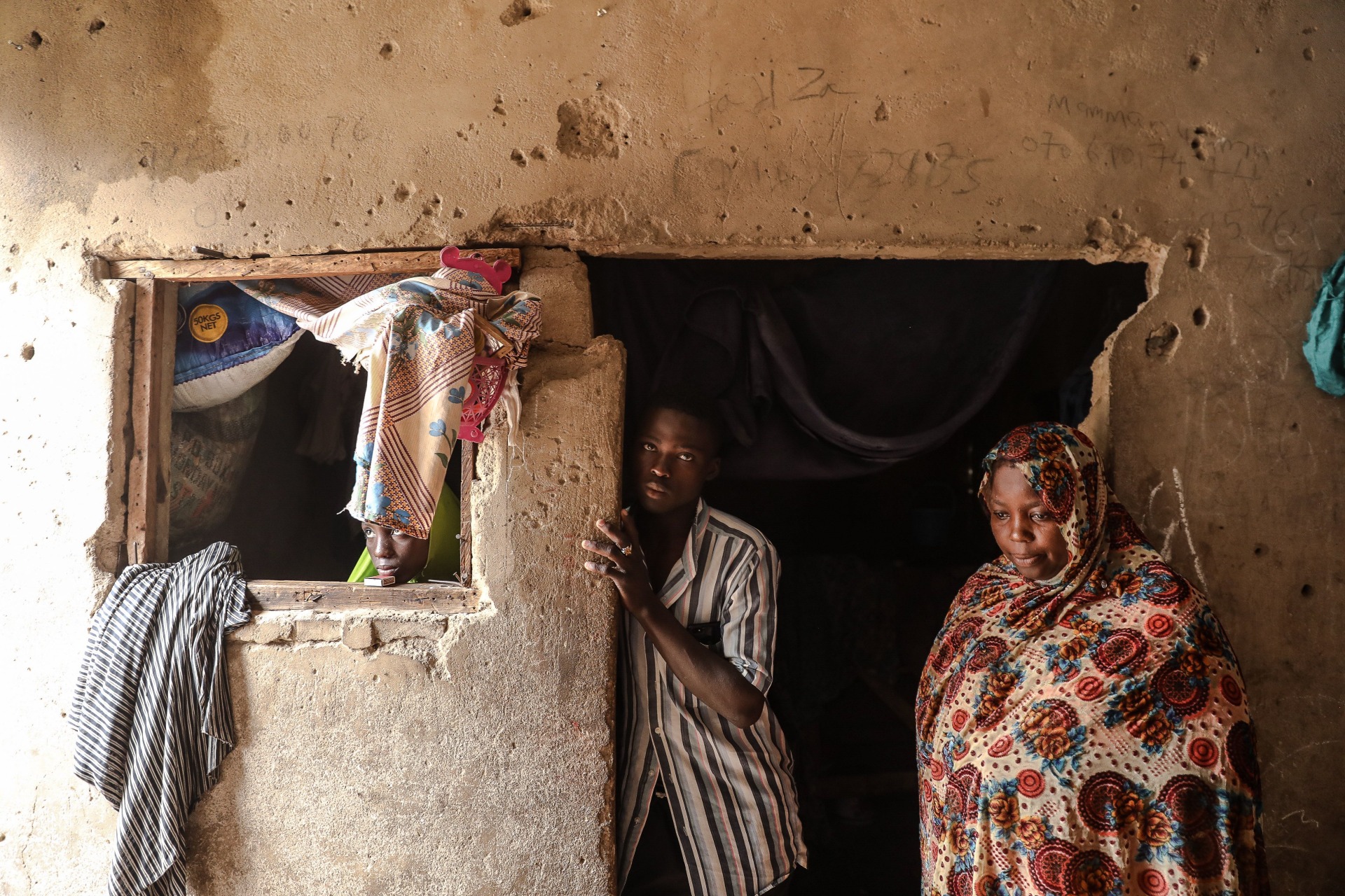<p>Hadiza, an internally displaced person from Baga local government area in Borno State in Nigeria, poses with family members on July 21, 2019, in Markas, the mosque of Boko Haram leader Mohammed Yusuf in Old Maiduguri where she currently resides.</p>
