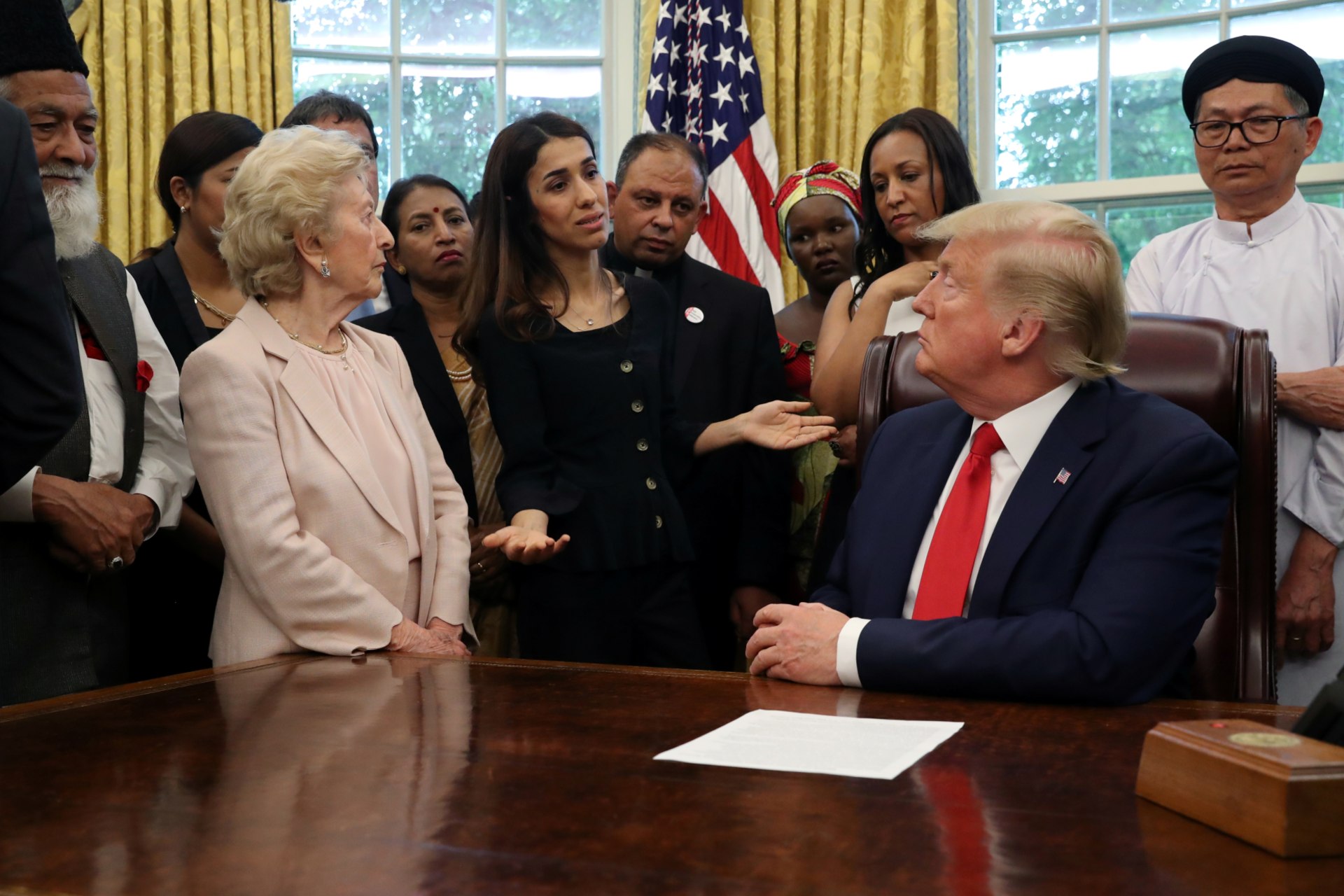 <p>President Donald J. Trump listens to Nadia Murad as he hosts a group of victims of religious persecution in the Oval Office of the White House. Washington, DC, United States. July 17, 2019.</p>
