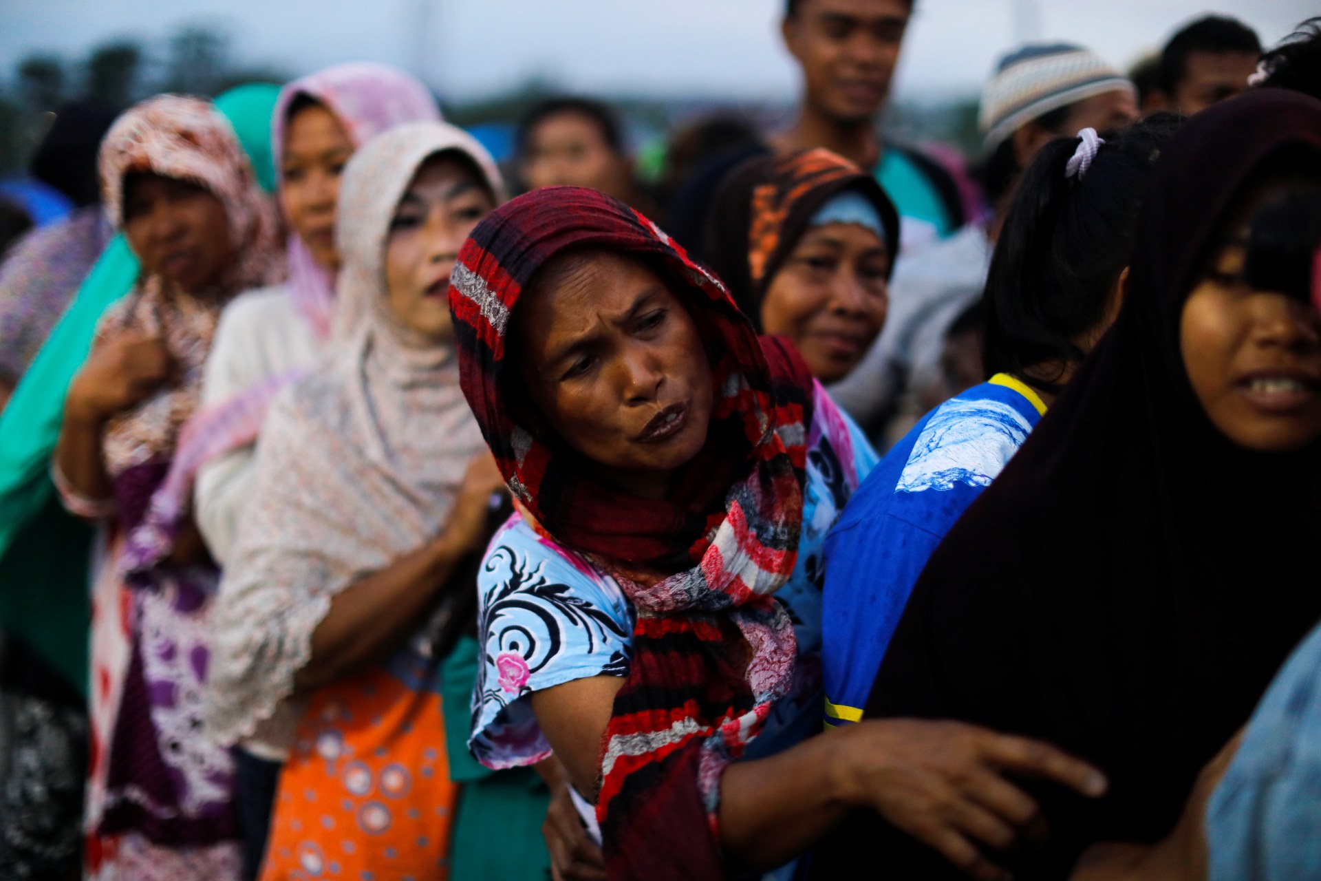 <p>Women line up to received food at a camp for displaced victims of the earthquake and tsunami in Palu, Indonesia.</p>
