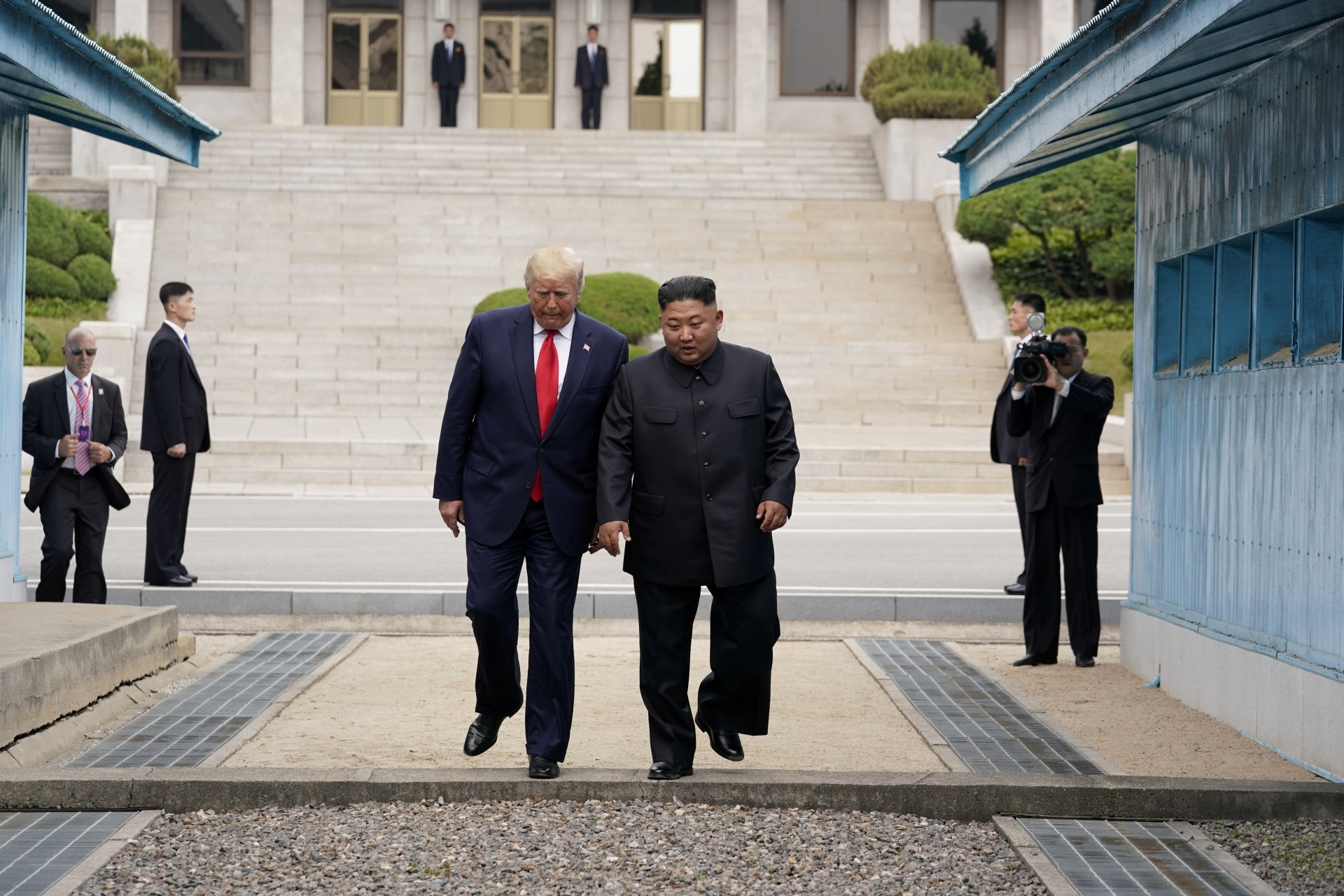 <p>U.S. President Donald J. Trump takes a historic first step with North Korean leader Kim Jong-un across the Demilitarized Zone (DMZ) that divides the two Koreas, in Panmunjom, South Korea, on June 30, 2019.</p>
