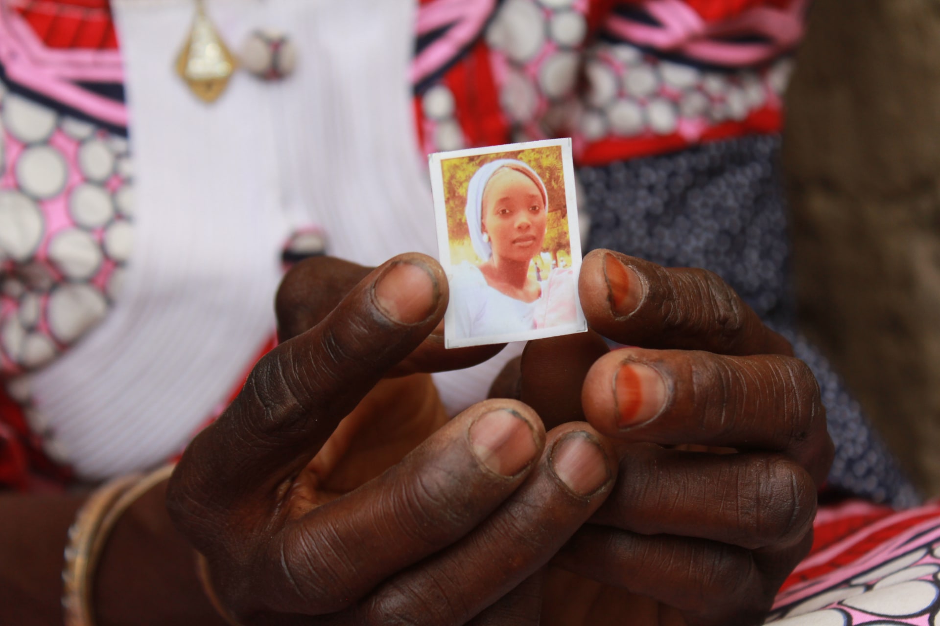 <p>Zainabu Mala, mother of Kabu, one of the abducted girls, holds a picture of her daughter on April 12, 2019, in Chibok.</p>