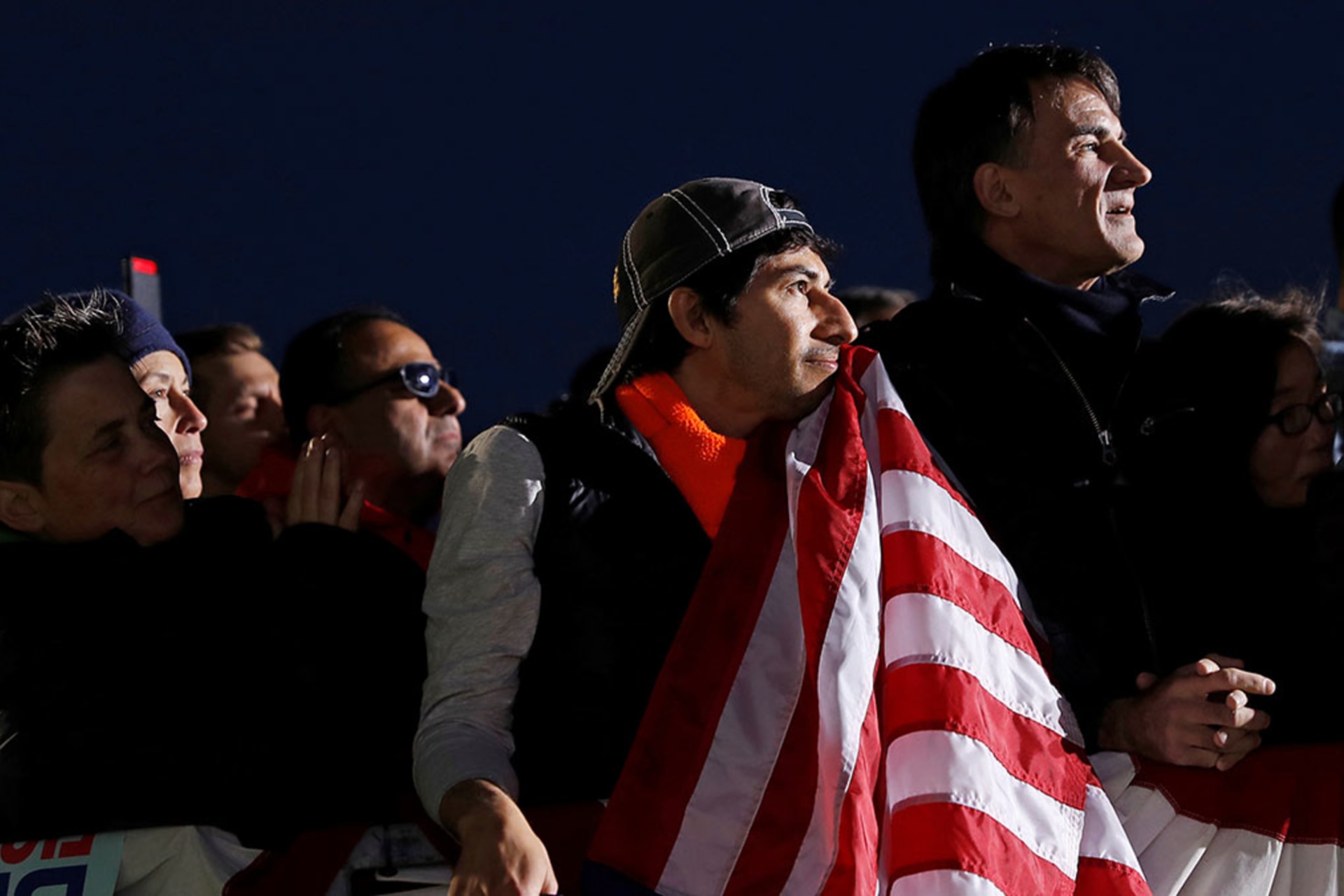 <p>U.S. Air Force veteran Gerardo Marin holds a flag while listening to 2020 Democratic presidential candidate U.S. Sen. Elizabeth Warren (D-MA) during a town hall event in Oakland, California.</p>
