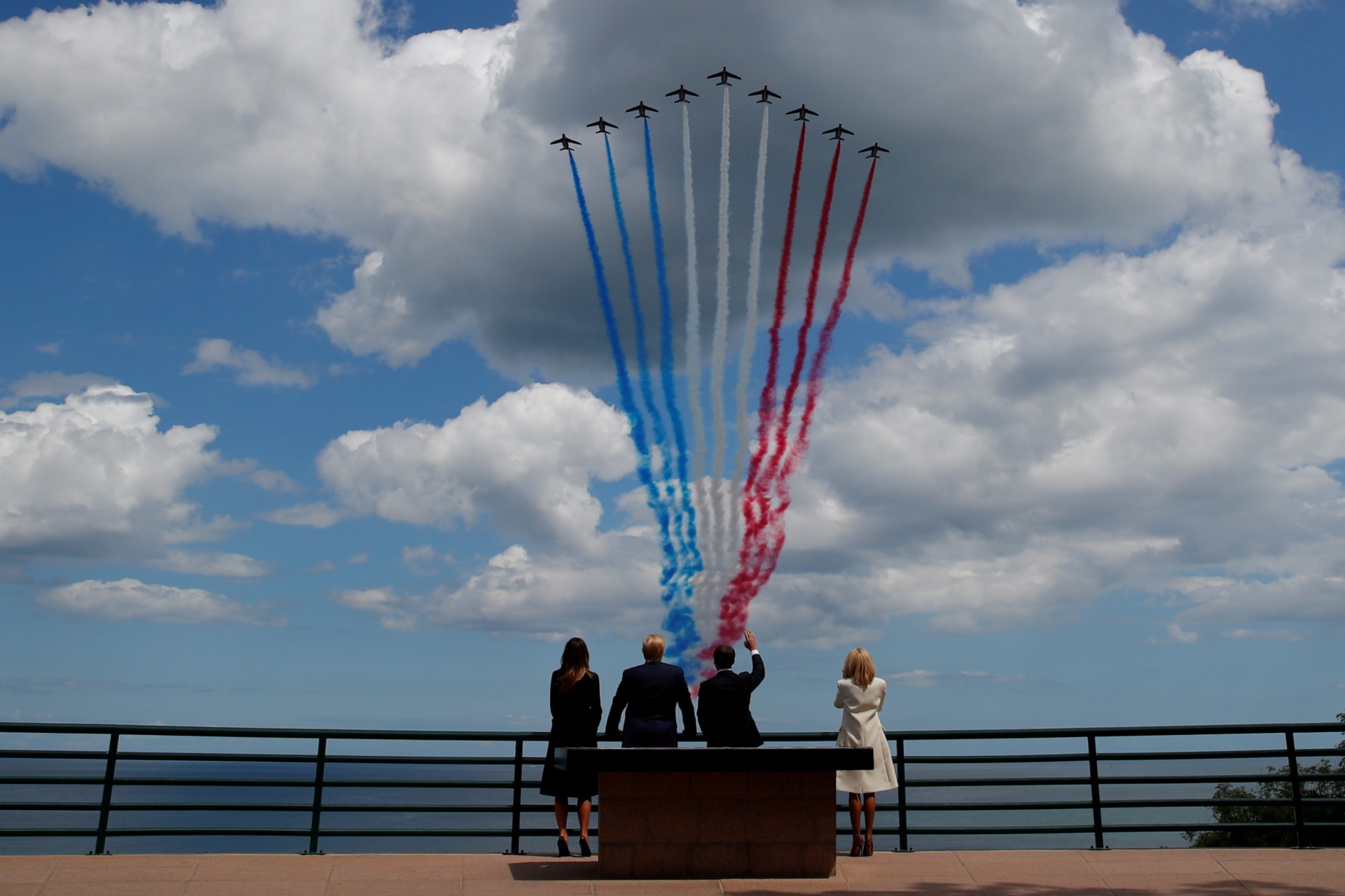 <p>U.S President Donald J. Trump, First Lady Melania Trump, French President Emmanuel Macron, and his wife Brigitte Macron look to flypasts to commemorate the 75th anniversary of the D-Day landings in Normandy, France, June 6, 2019.</p>