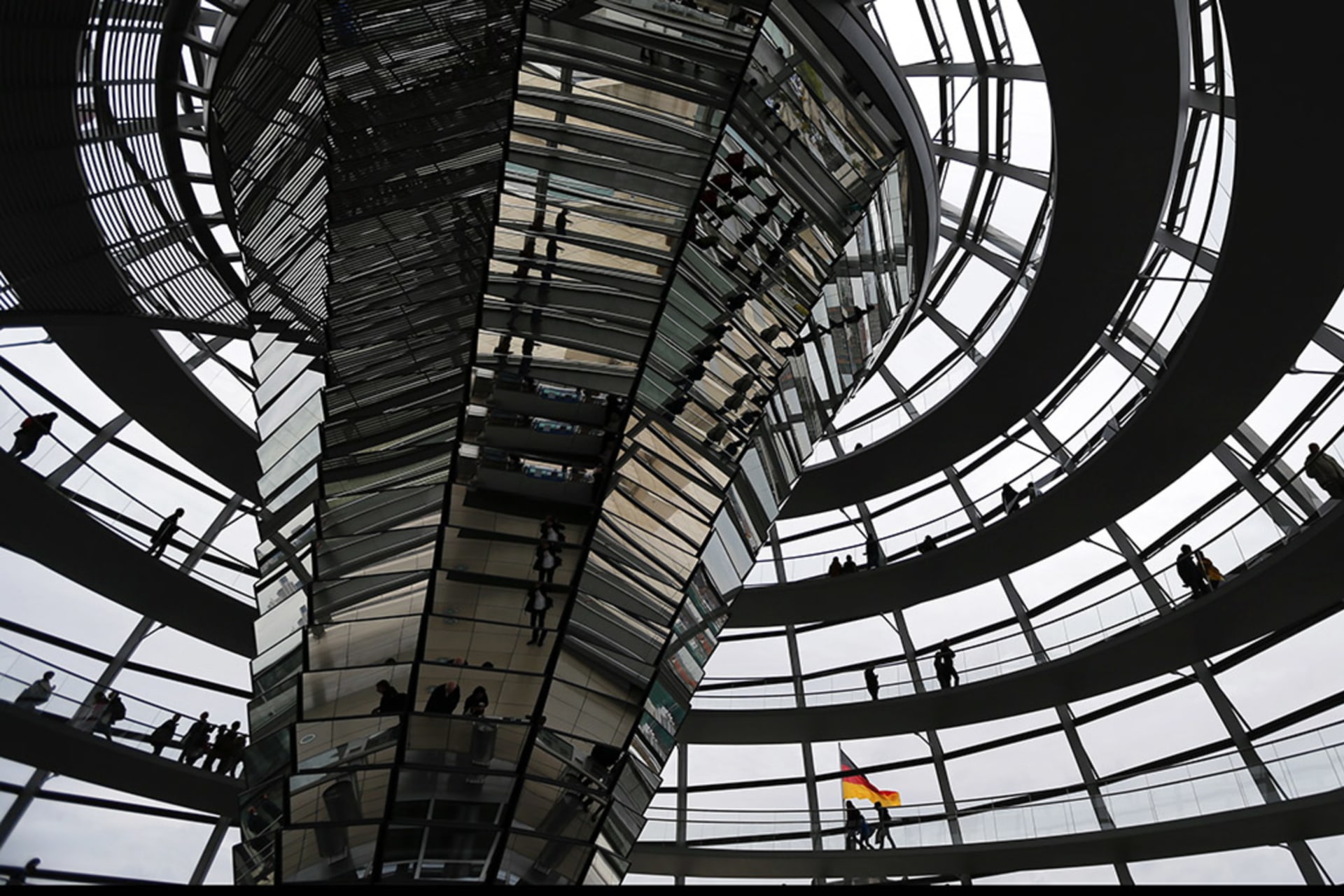 <p>People walk inside the dome of the Reichstag building in Berlin. </p>
