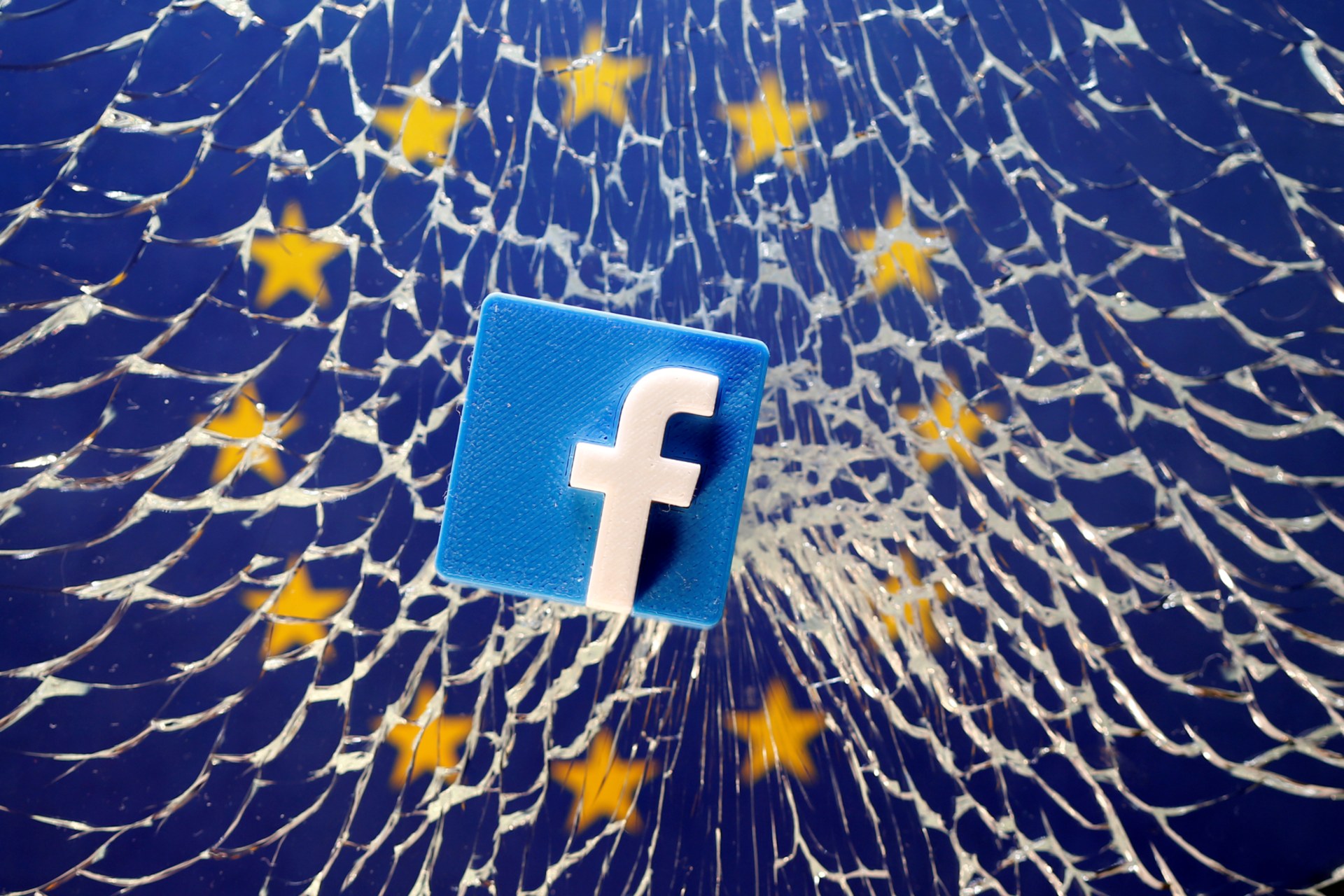 <p>A Facebook logo is placed on broken glass above a printed EU flag in this illustration taken January 28, 2019. </p>
