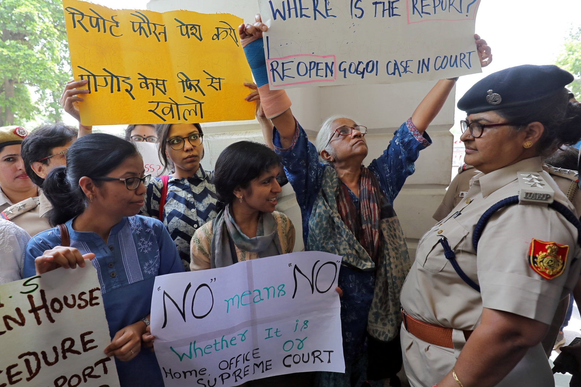 <p>Demonstrator hold placards during a protest after a panel of judges dismissed a sexual harassment complaint against Chief Justice of India (CJI) Ranjan Gogoi in New Delhi, India, May 8, 2019.</p>