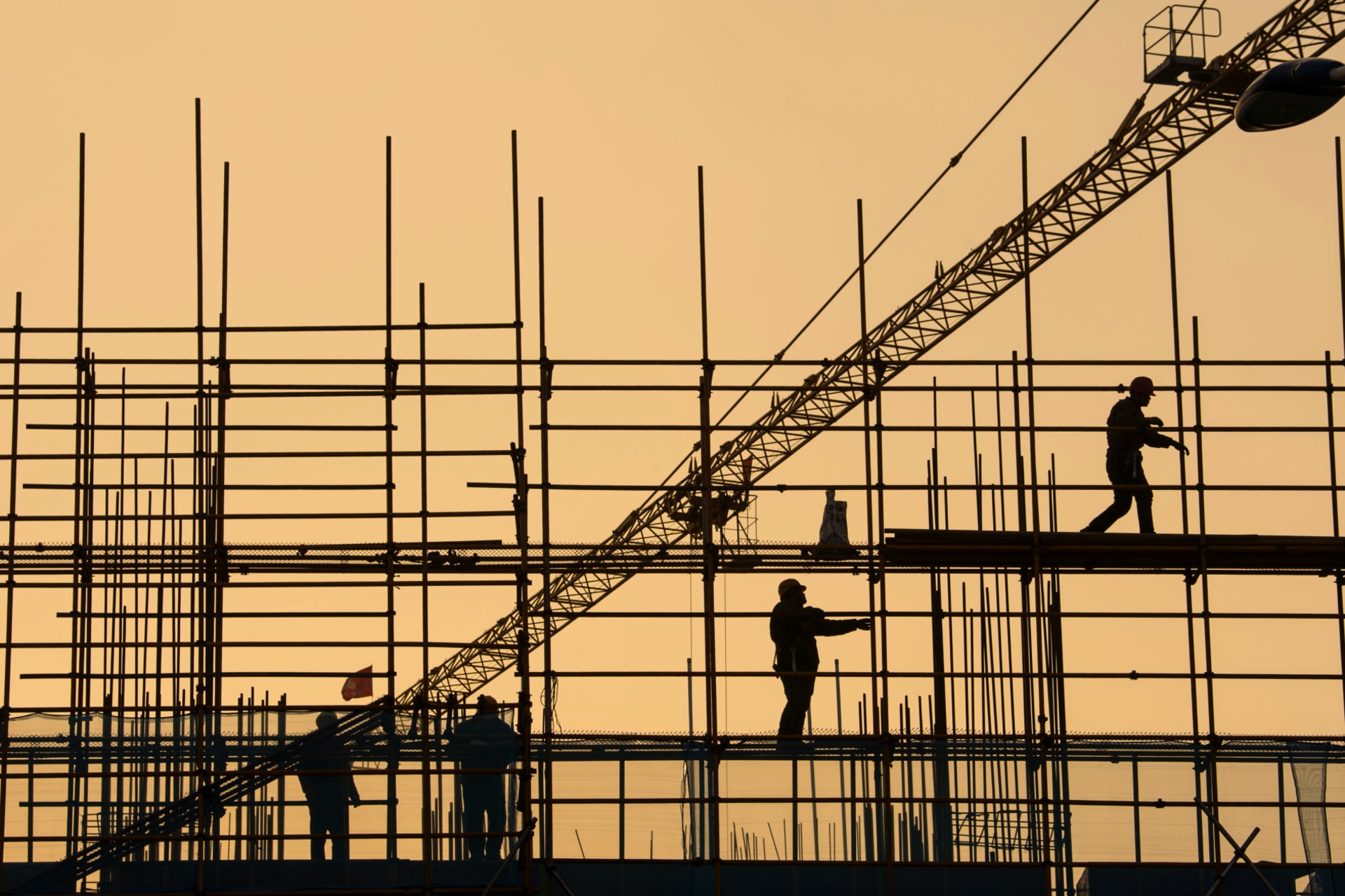 <p>Workers are seen on scaffolding at a construction site in Nantong, Jiangsu province, China, on January 1, 2019.</p>

