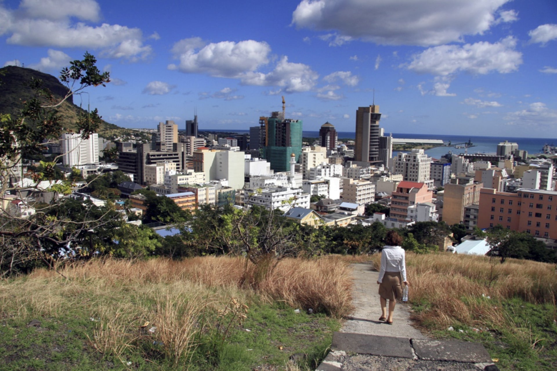 <p>A woman walks down a hill to Port Louis on June 6, 2008, in Mauritius.</p>
