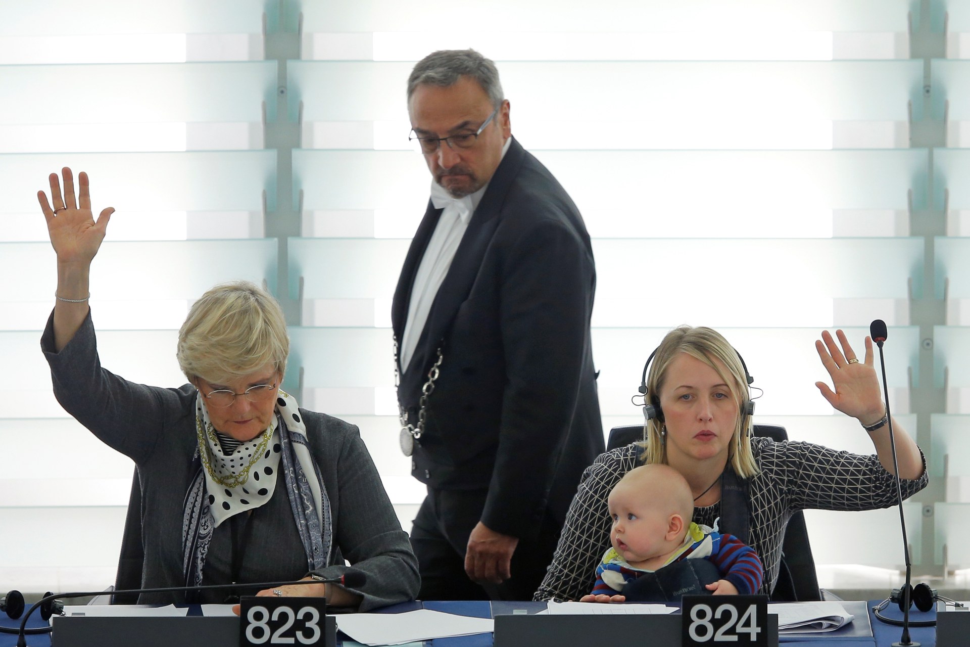 <p>Swedish Member European Parliament Jytte Guteland (R) holds her baby as she takes part in a voting session at the European Parliament.</p>