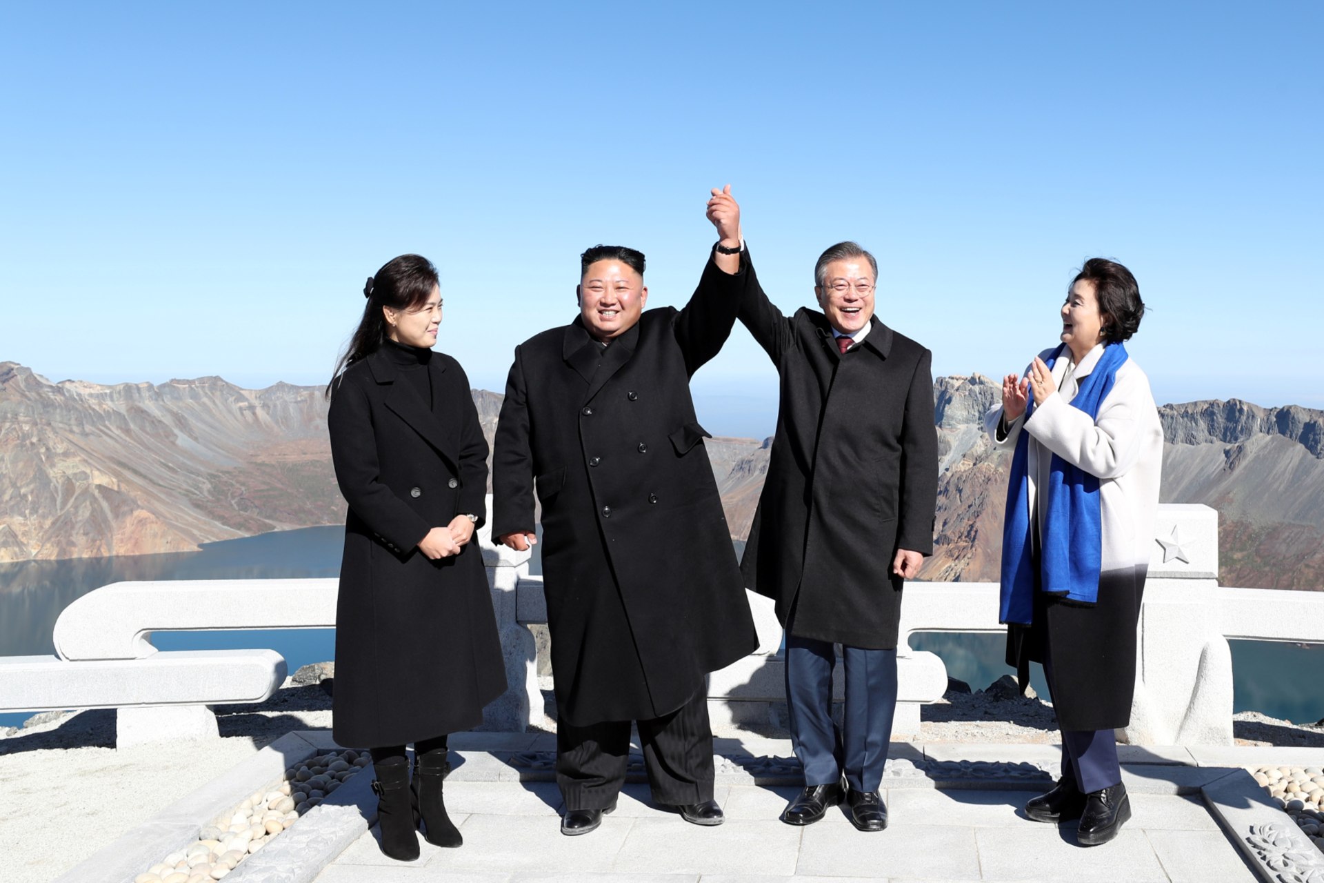 <p>North Korean leader Kim Jong-un and South Korean President Moon Jae-in pose for photographs on the top of Mt. Paektu, North Korea, on September 20, 2018.</p>