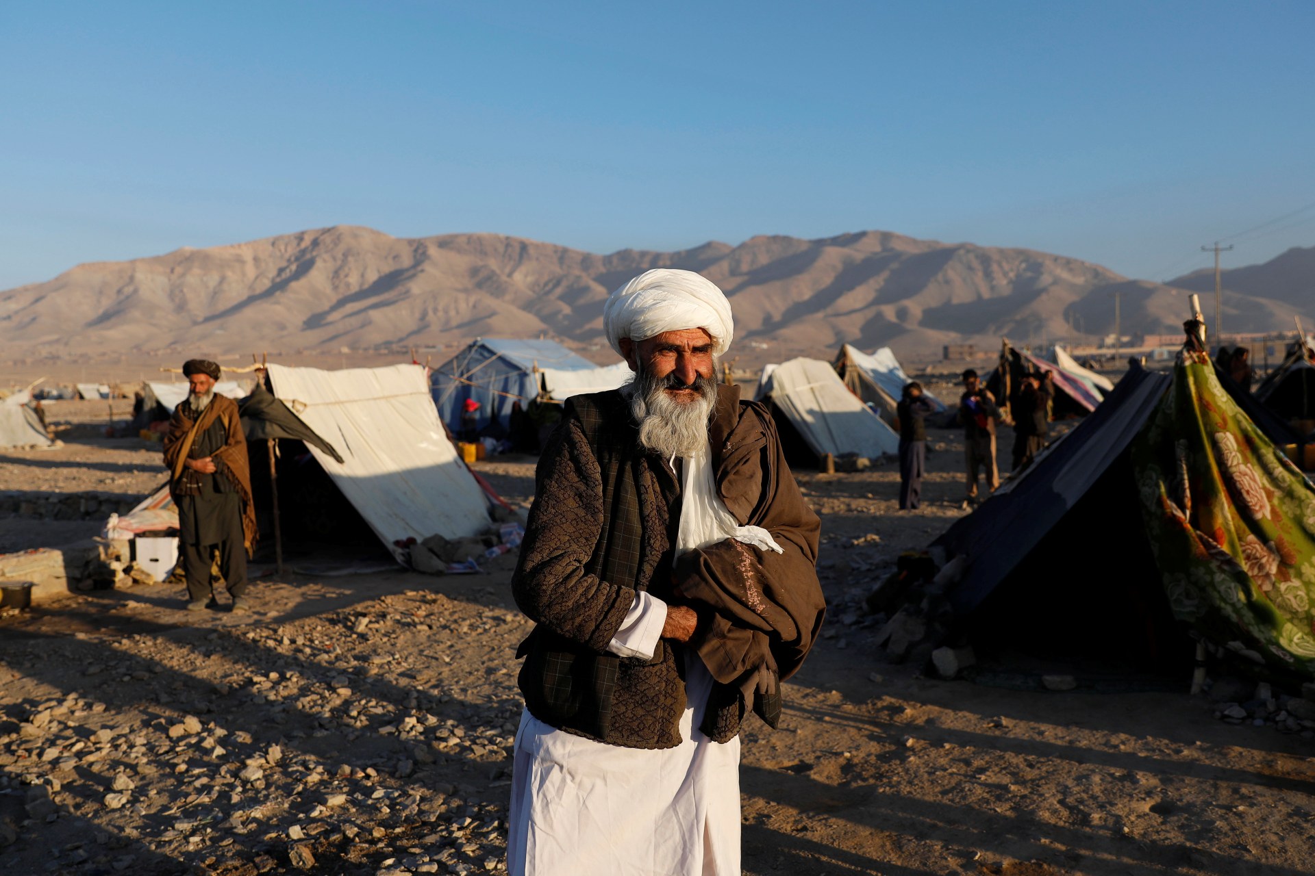 <p>An internally displaced Afghan man walks around a refugee camp in Herat Province, Afghanistan, on October 14, 2018. </p>