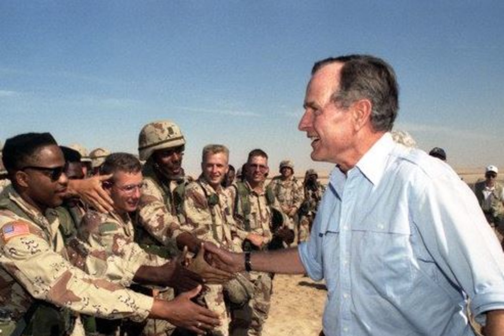 <p>President George H.W. Bush greets troops in Saudi Arabia during a 1990 Thanksgiving visit. </p>
