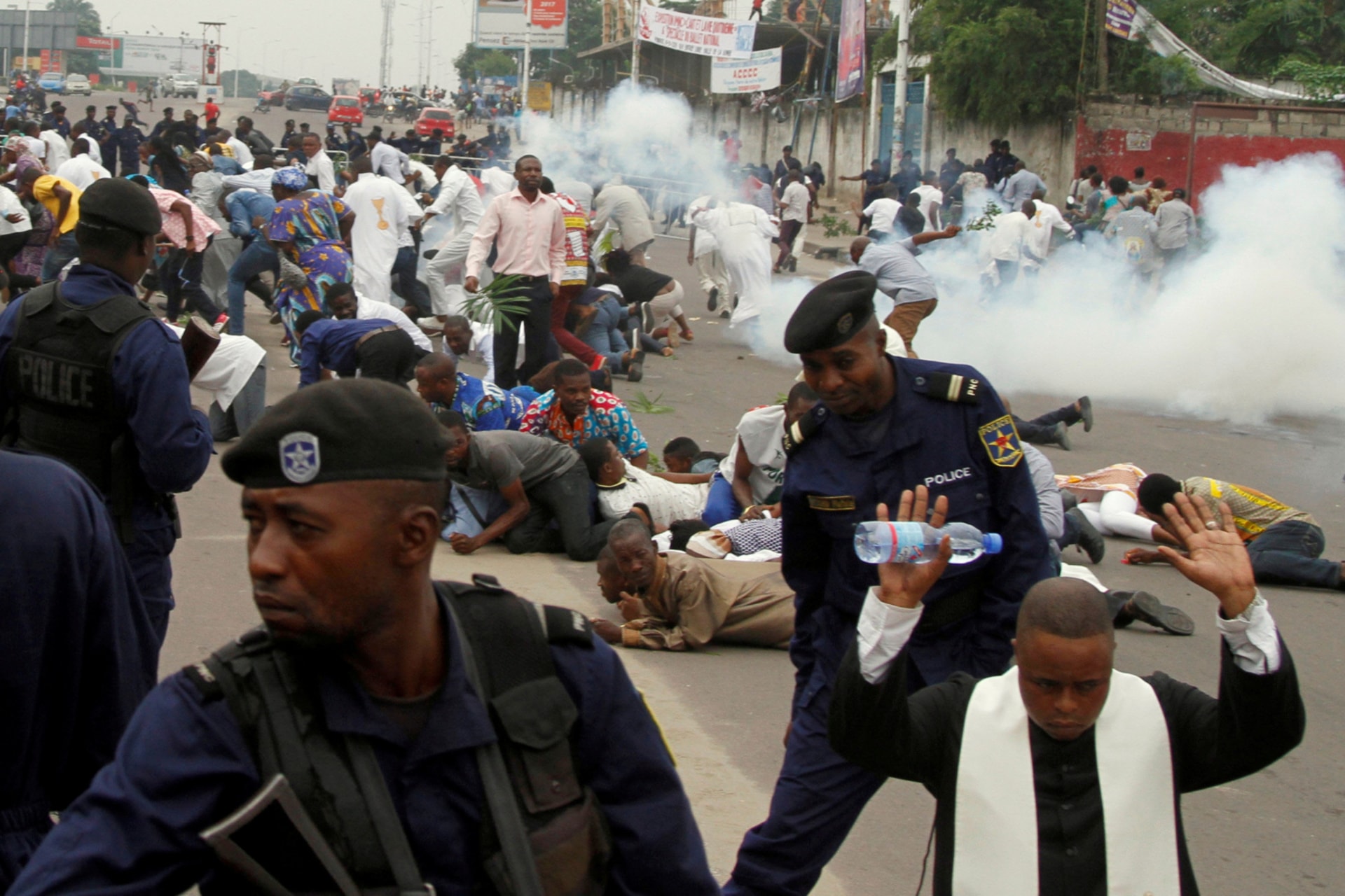 <p>Riot policemen fire tear gas to disperse Catholic priests and demonstrators during a protest against President Joseph Kabila organized by the Catholic church in Kinshasa, Democratic Republic of Congo, on January 21, 2018.</p>
