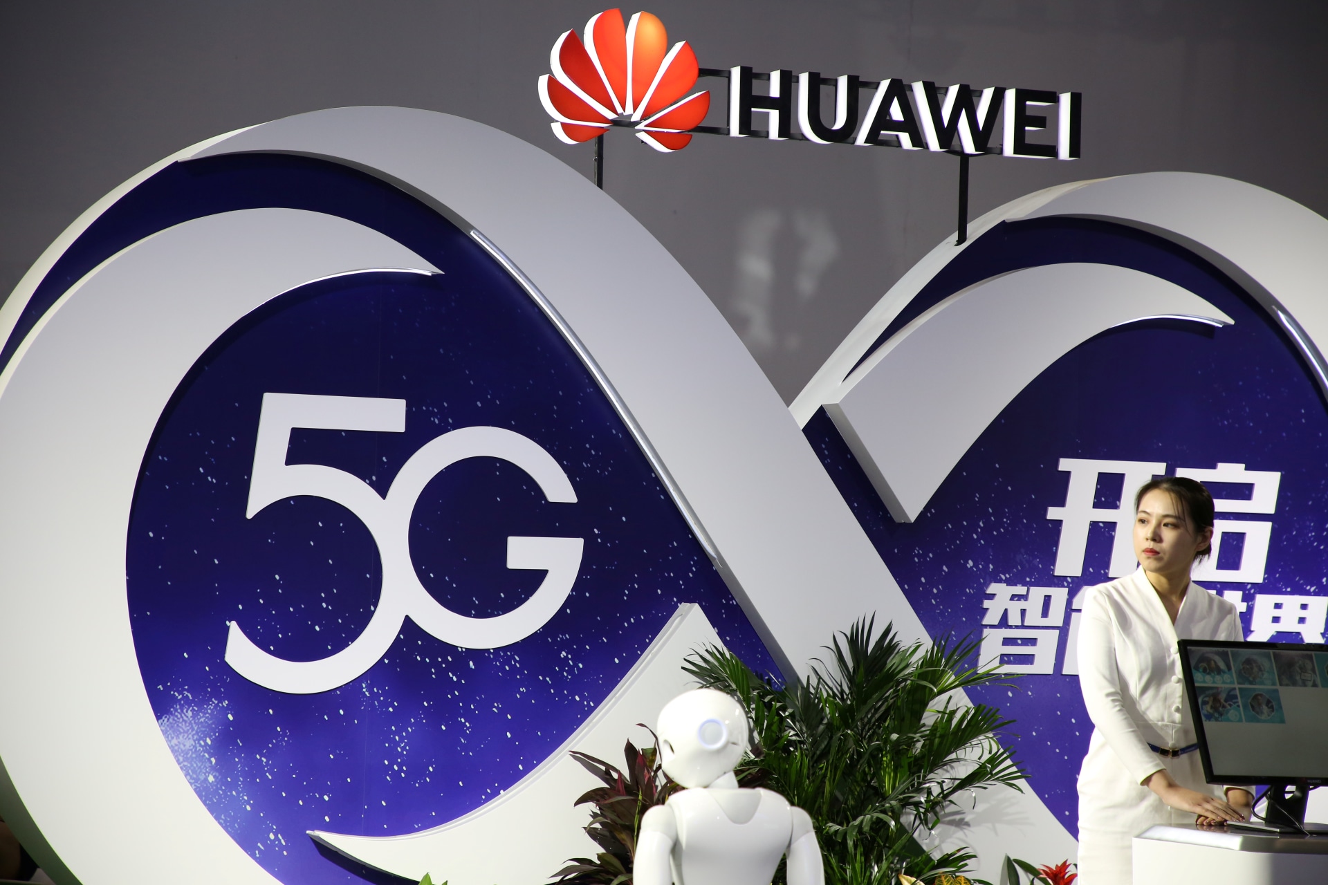 <p>A woman stands at the booth of Huawei featuring 5G technology at the PT Expo in Beijing in 2018.</p>