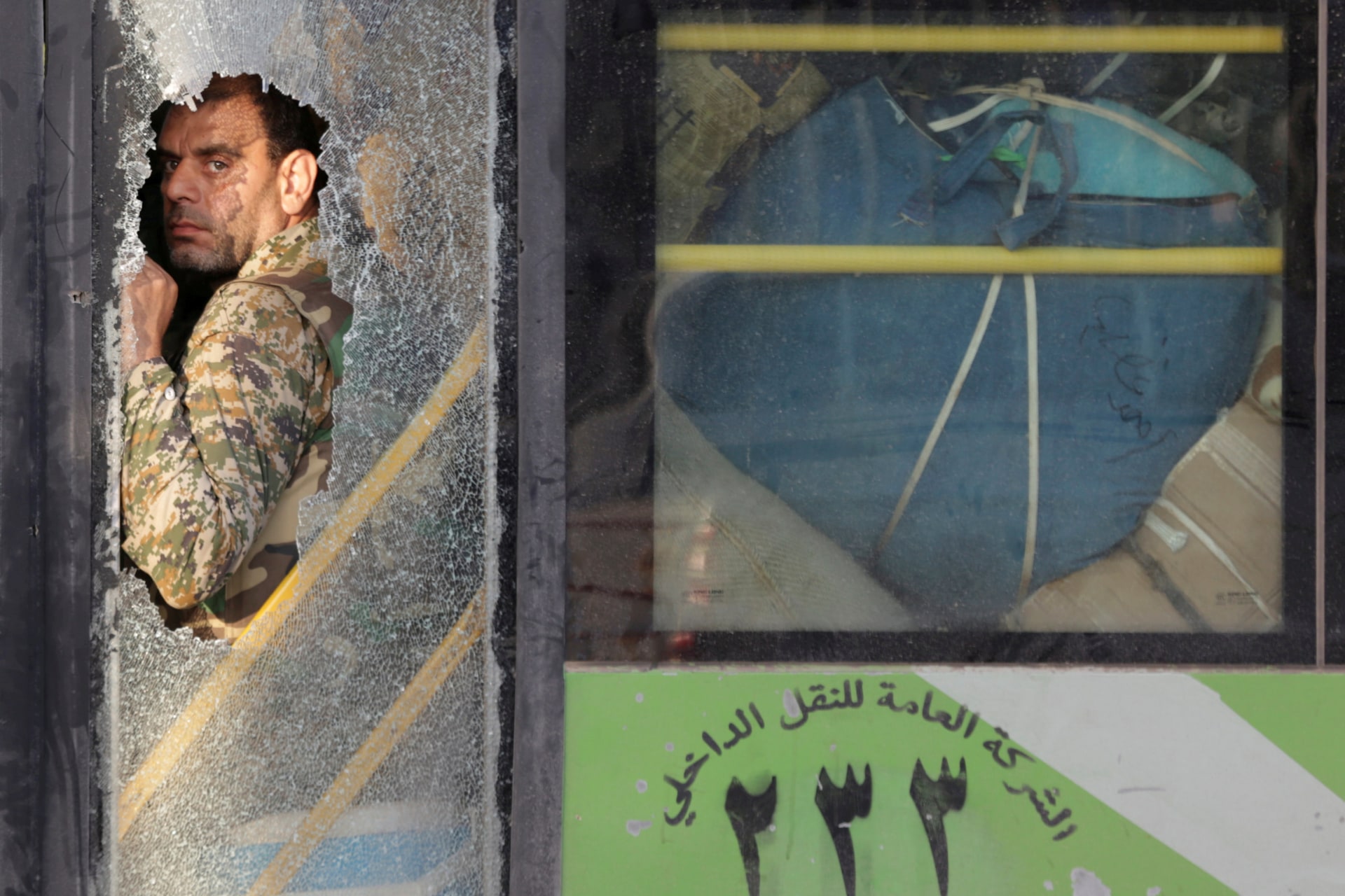 <p>A fighter loyal to Syrian President Bashar al Assad during the evacuation from the villages of al Foua and Kefraya in Syria July 19, 2018. </p>