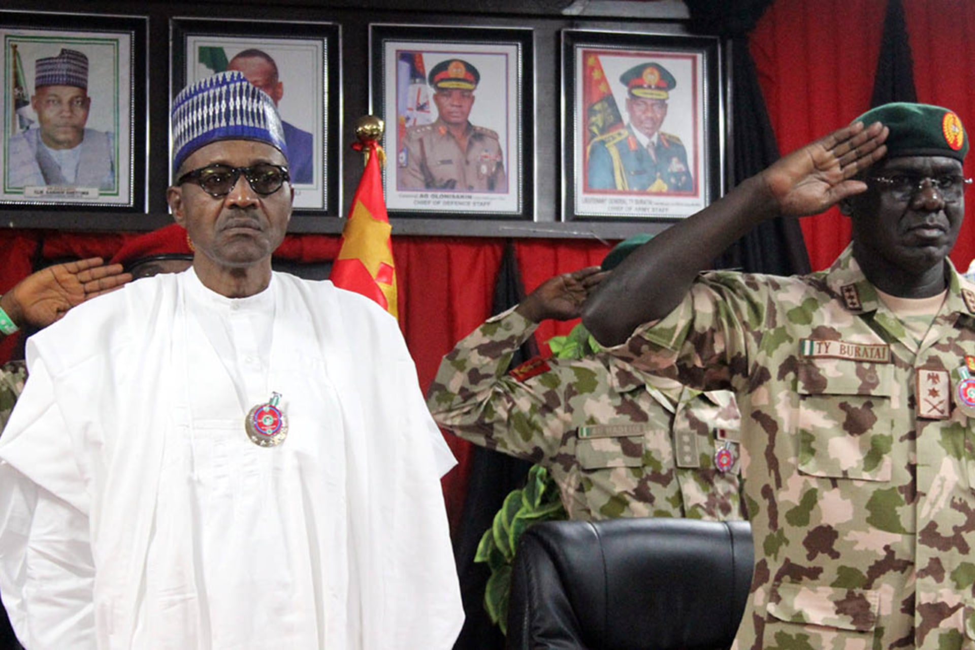 <p>Nigerian President Muhammadu Buhari next to Nigeria Chief of Army Staff Tukur Buratai during the opening ceremony of the military staff annual conference, on November 28, 2018, as part of his trip to visit troops on front lines of the Boko Haram.</p>
