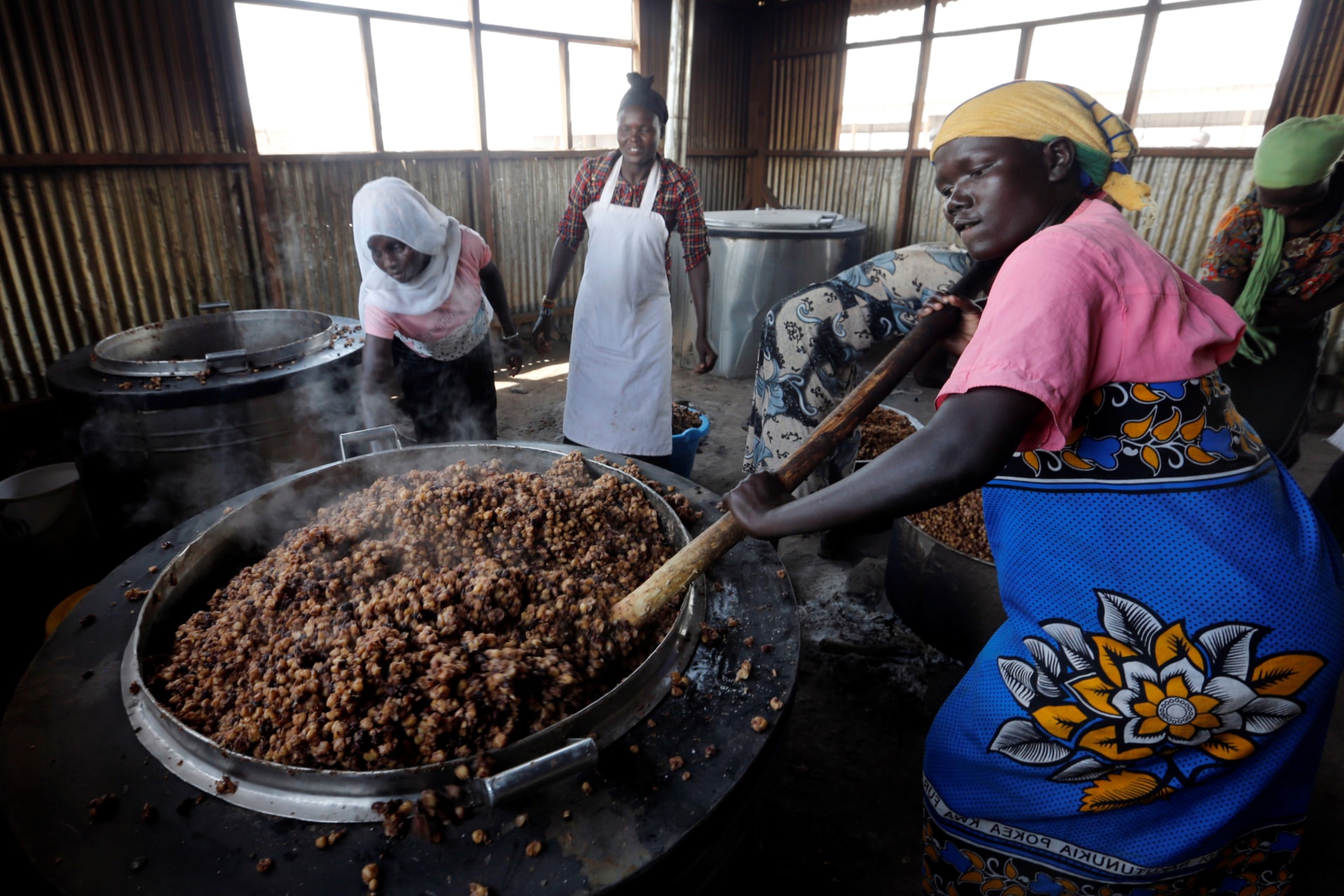<p>South Sudanese volunteers prepare food for refugees at Kalobeyei Primary school within Kalobeyei Settlement outside the Kakuma refugee camp in Turkana county, northwest of Nairobi, Kenya, on January 31, 2018. </p>