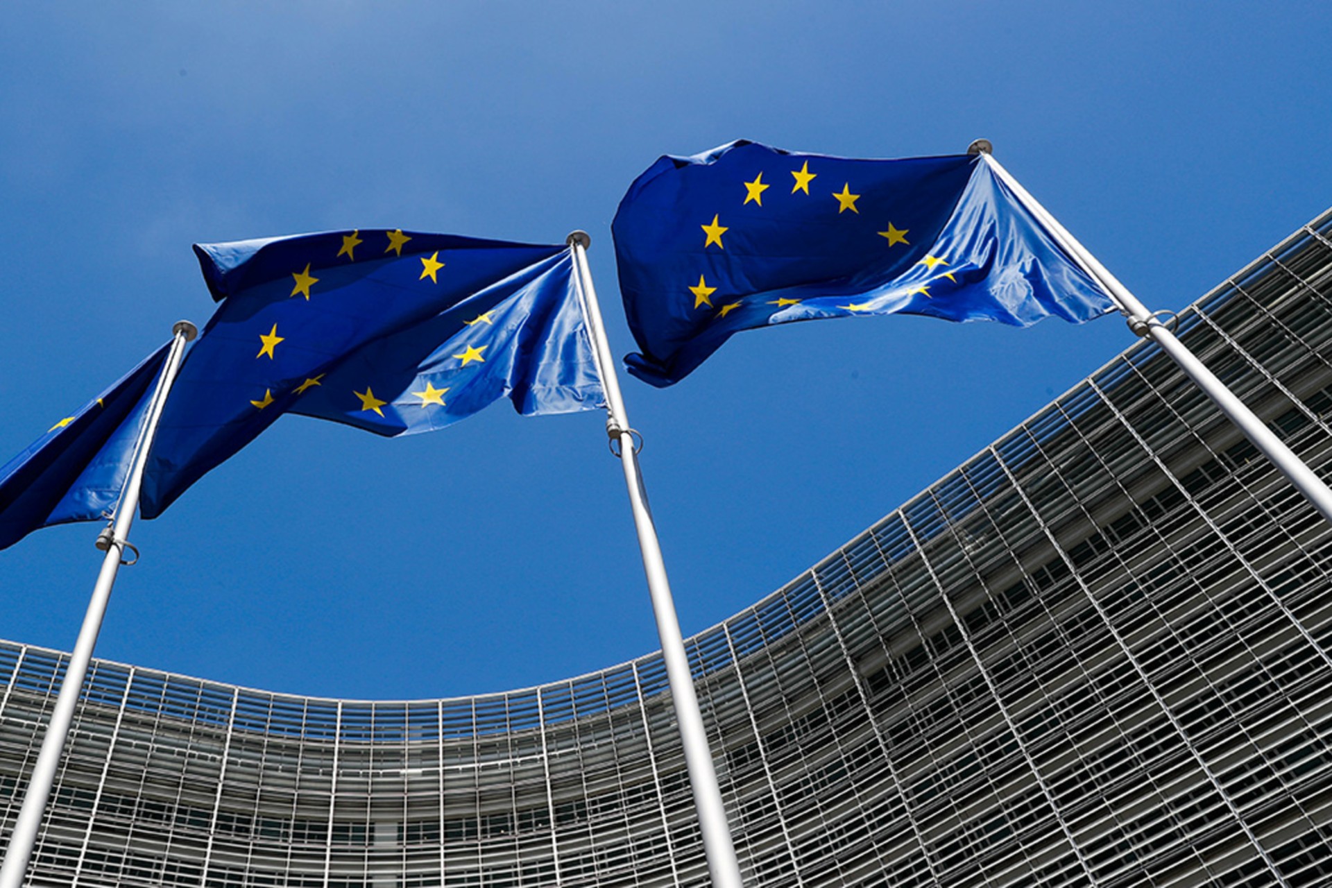 <p>European Union flags fly in 2018 outside the European Commission headquarters in Brussels, Belgium. Brussels effectively serves as the EU’s capital.</p>