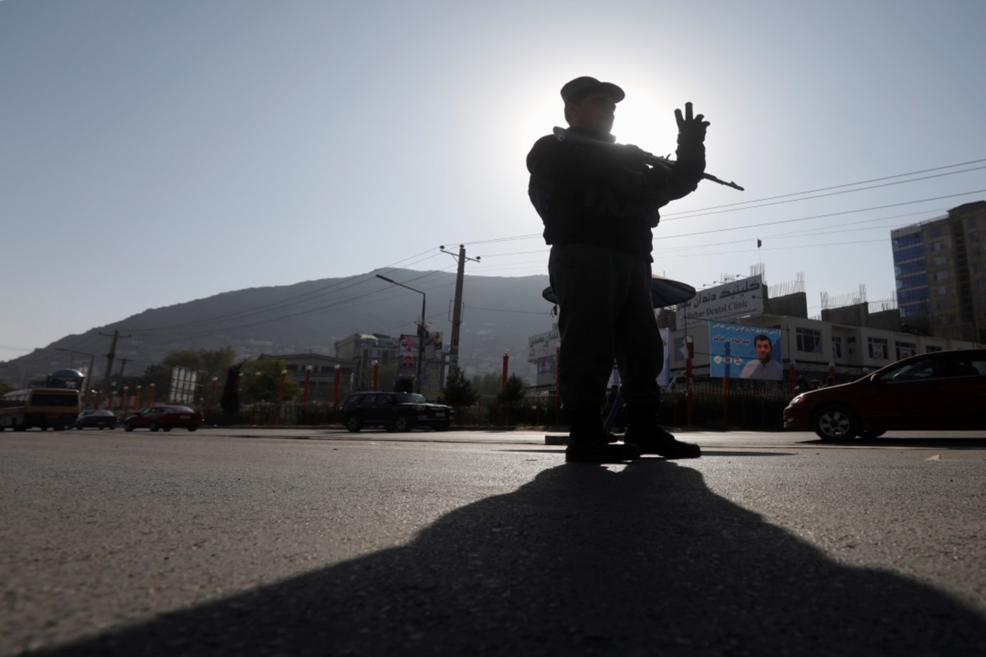 <p>An Afghan policeman stands guard at a checkpoint in Kabul, Afghanistan, on October 19, 2018, a day before parliamentary elections.</p>
