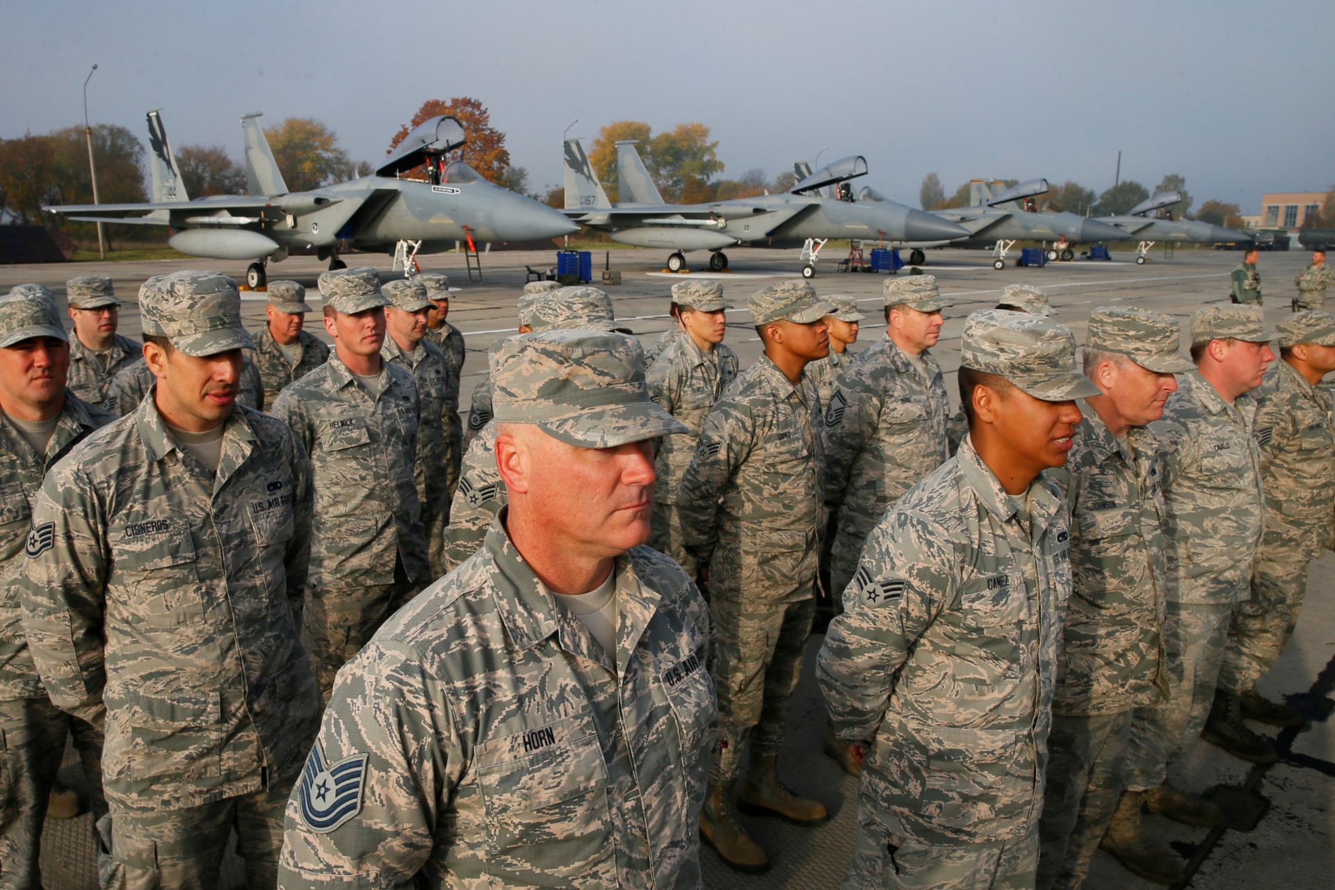 <p>U.S. servicemen stand in line in front of F-15 fighter jets during the opening ceremony of the Clear Sky 2018 multinational military drills at Starokostiantyniv Air Base in Ukraine on October 12, 2018. </p>
