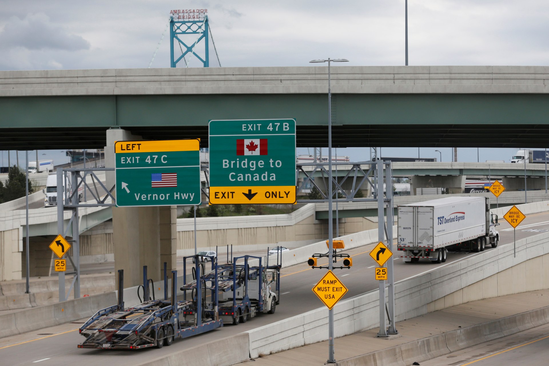 <p>Semi trucks headed for Windsor, Ontario, exit onto the lane towards the Ambassador bridge in Detroit, Michigan on April 26, 2017.</p>