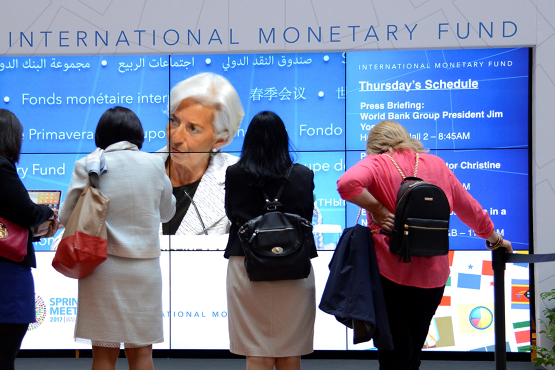 <p>Visitors watch IMF Managing Director Christine Lagarde during the opening of the IMF and World Bank Annual Spring Meetings in Washington, DC, in 2017.</p>