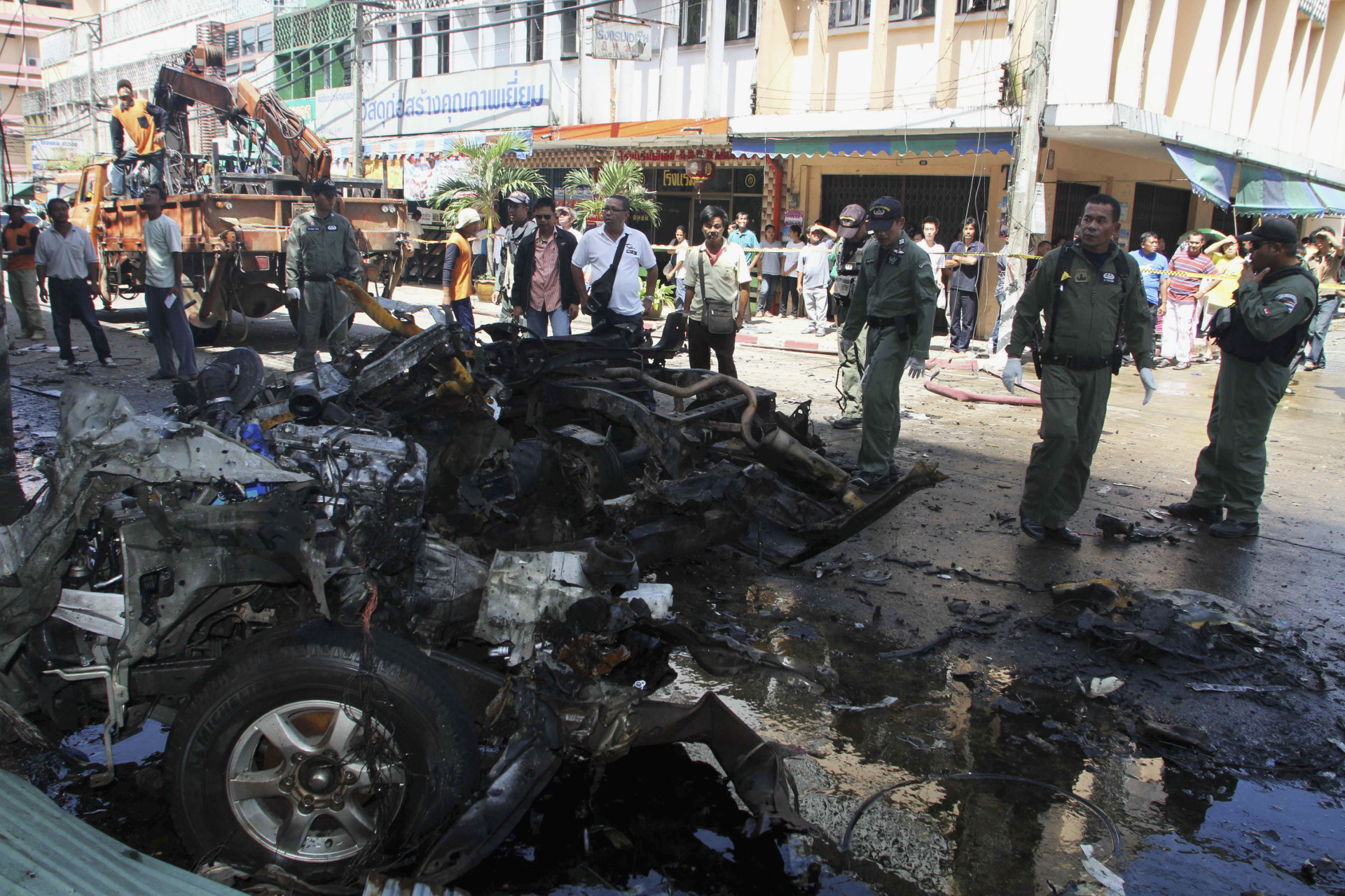 <p>Thai security personnel inspect a remains of a pick-up truck, at the site of a bomb attack in southern Thailand’s Narathiwat province on July 20, 2012. </p>
