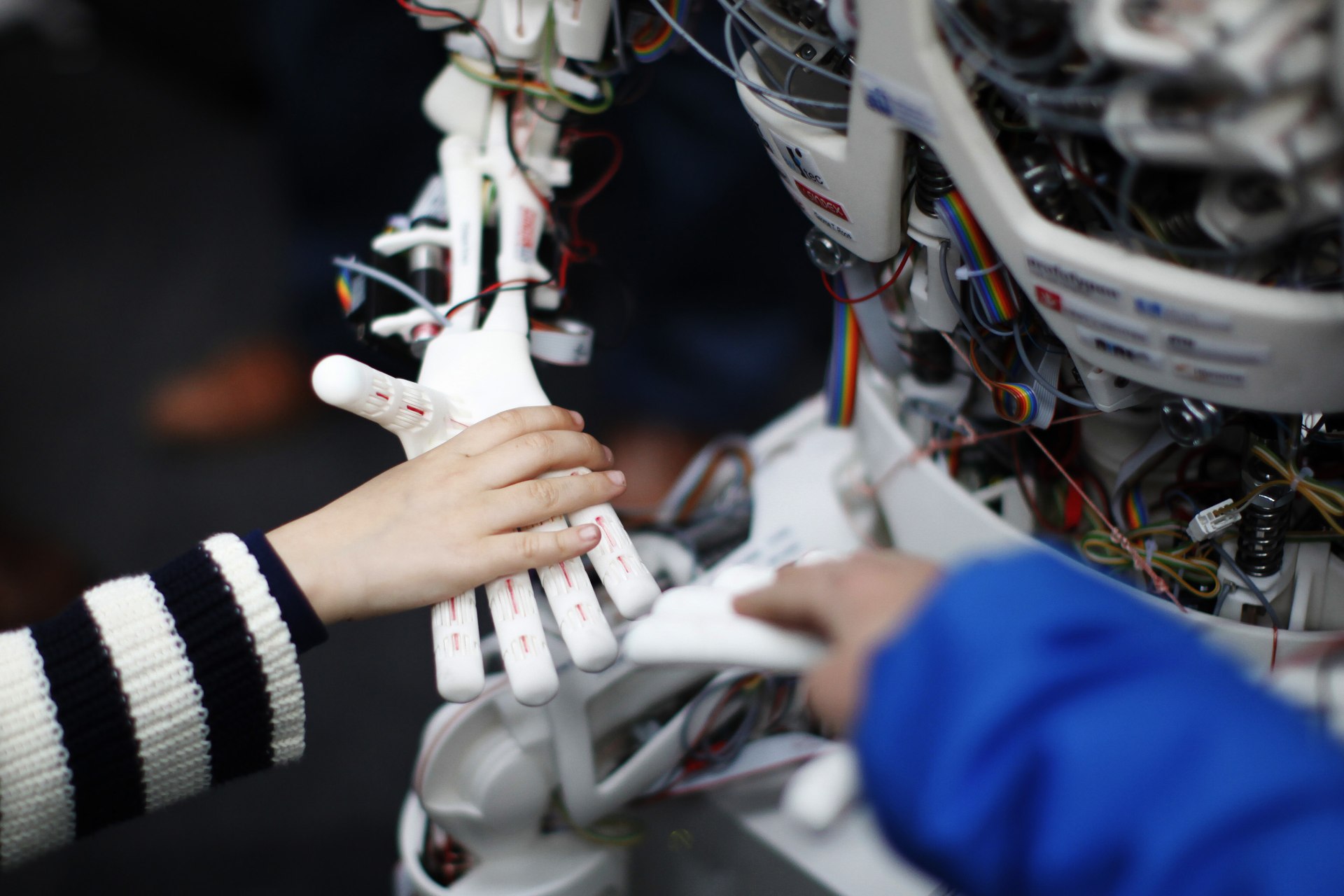 <p>Children touch the hands of the humanoid robot Roboy at the exhibition Robots on Tour in Zurich on March 9, 2013. </p>