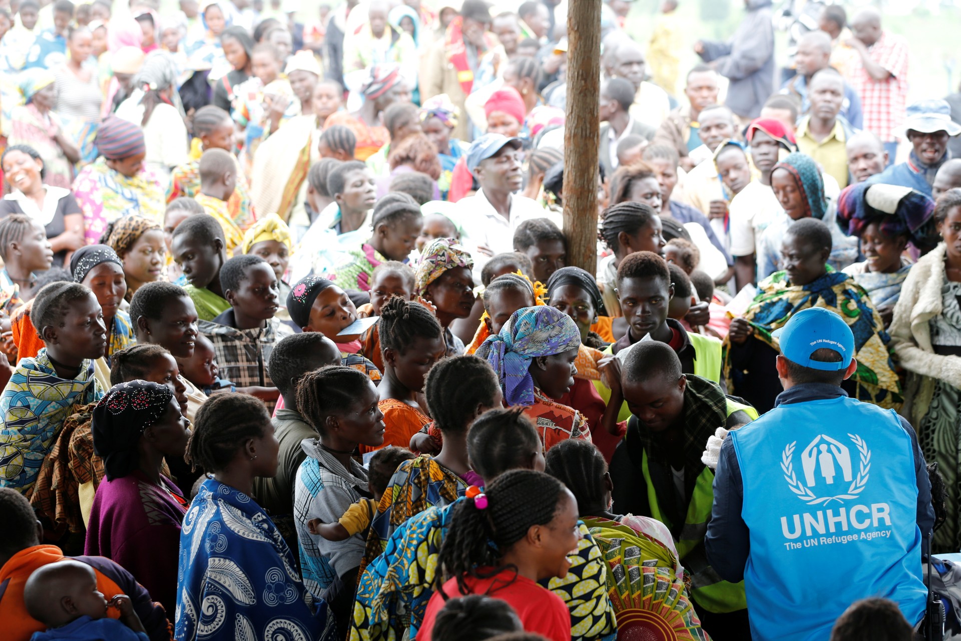 <p>A UN worker monitors Congolese refugees who fled from Democratic Republic of Congo by boat across Lake Albert, upon arrival at United Nations High Commission for Refugees (UNHCR) in a settlement camp in Kyangwali, Uganda, March 19, 2018.</p>
