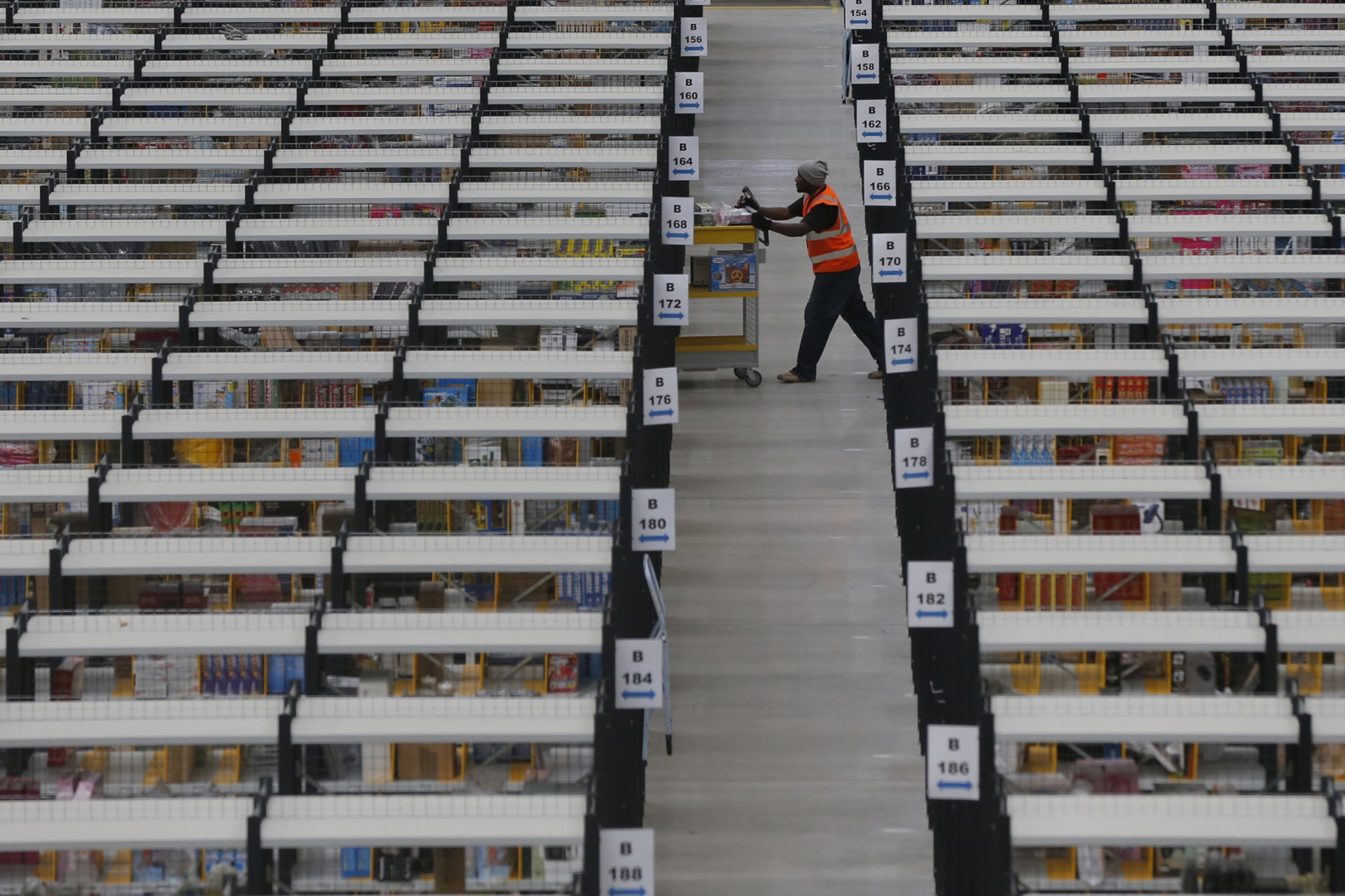 <p>A worker collects orders at Amazon’s fulfilment centre in Rugeley, central England December 11, 2012. </p>

