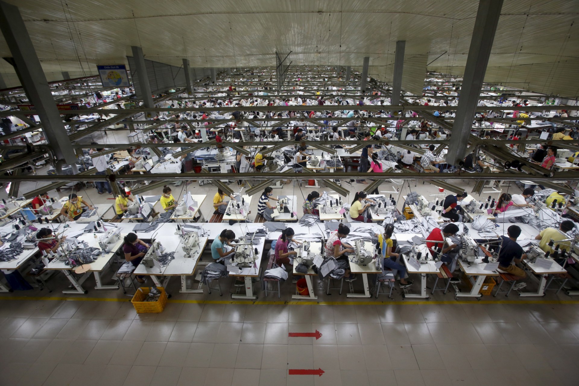 <p>Laborers work at a garment factory in Bac Giang province, near Hanoi, Vietnam on October 21, 2015.</p>
