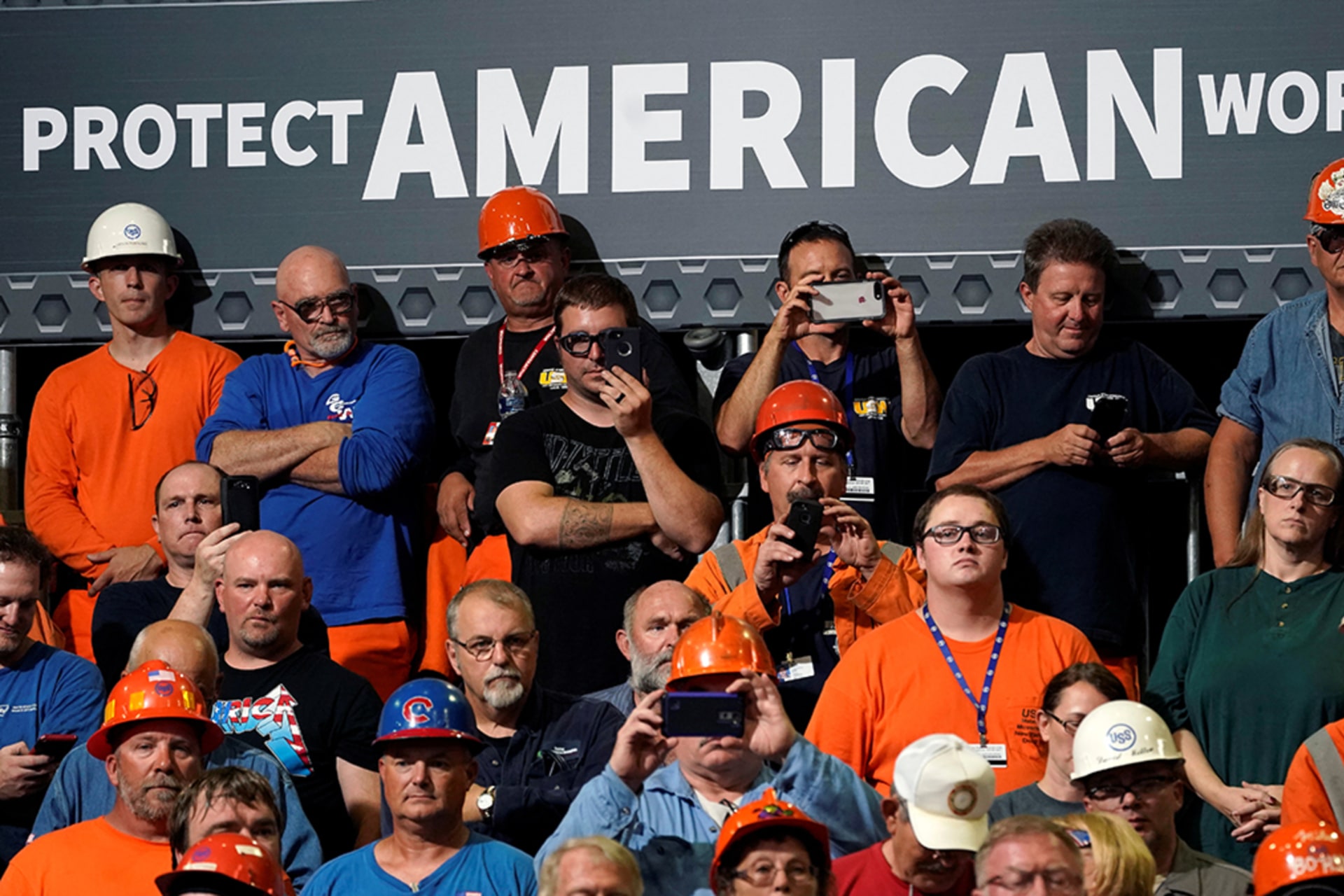 <p>Steelworkers watch President Donald J. Trump speak about trade policy at a steel plant in Granite City, Illinois, on July 26, 2018.</p>