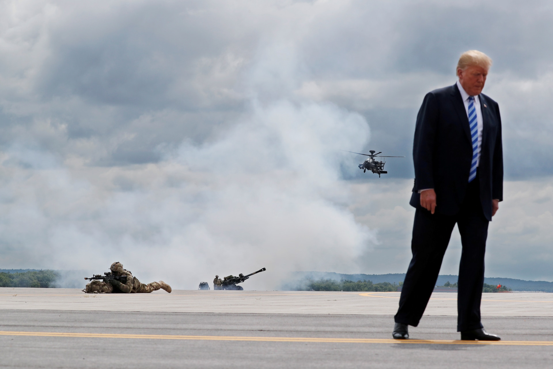 <p>U.S. President Donald Trump observes a demonstration with U.S. Army 10th Mountain Division troops, an attack helicopter, and artillery.</p>
