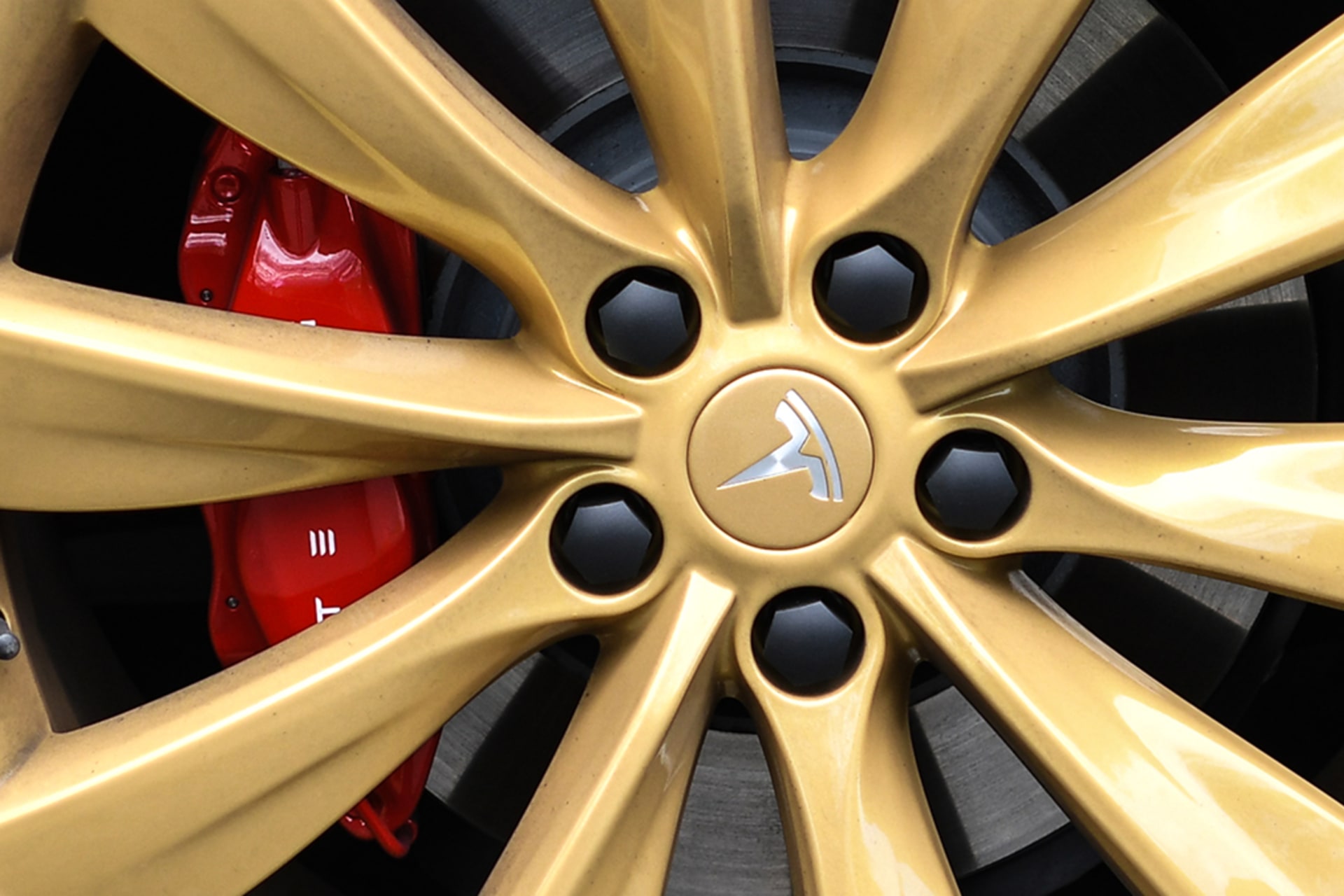 <p>A Tesla logo on the wheel of a Model S car at a launch event. </p>
