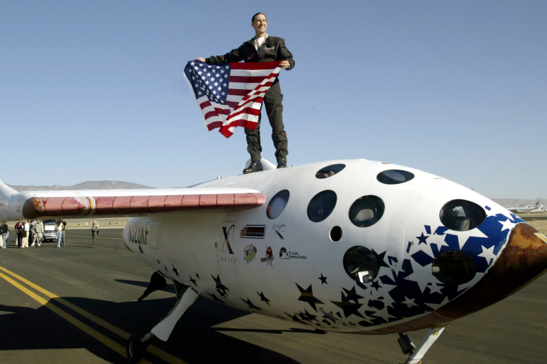 <p>Pilot Brian Binnie stands atop SpaceShipOne after winning the $10 million Ansari X Prize in Mojave, California October 4, 2004. The prize was awarded after SpaceShipOne became the first commercial spaceship to reach suborbit in two successful attempts.</p>
