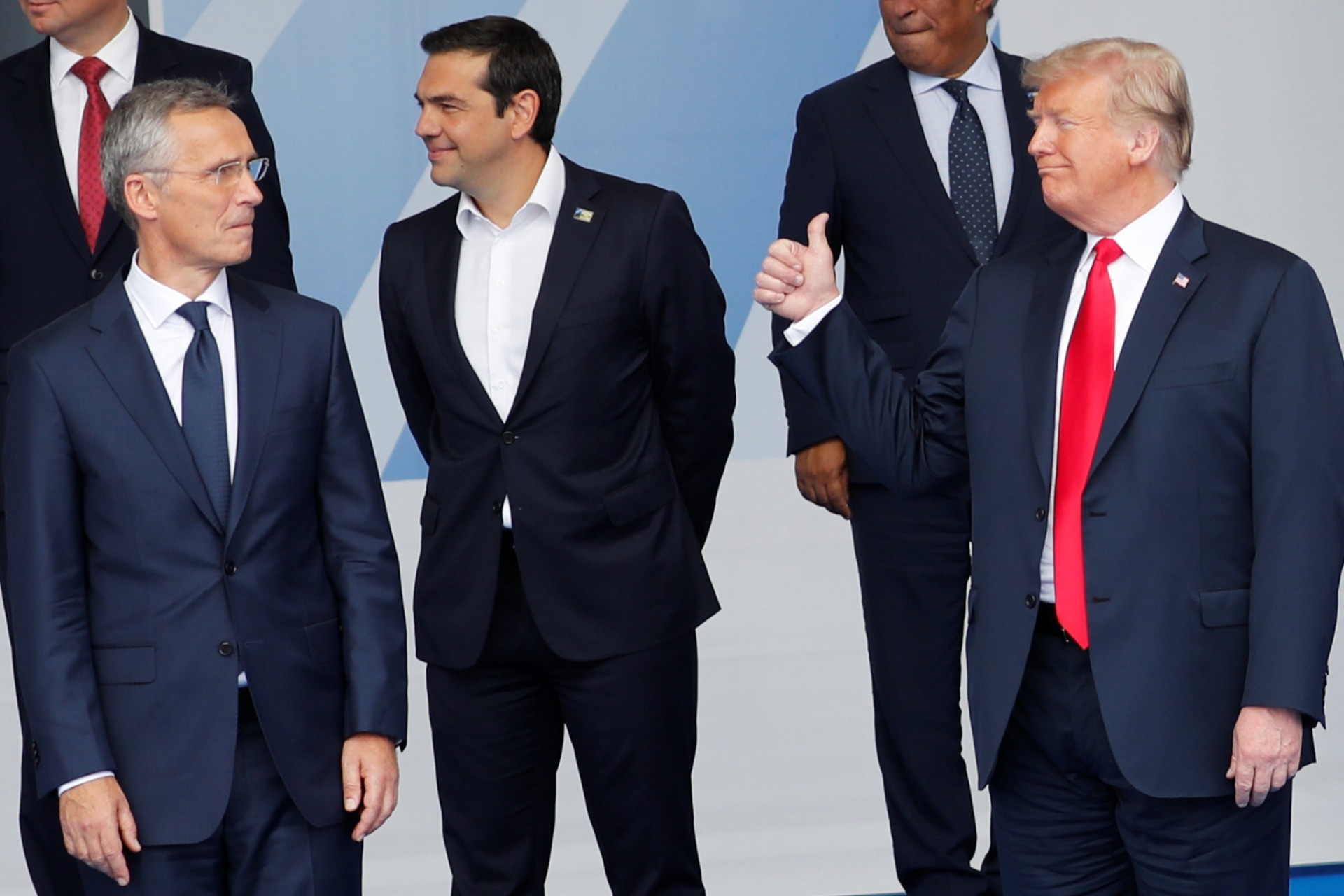 <p>U.S. President Donald Trump gestures as NATO leaders pose for a family photo at the start of the NATO summit in Brussels, Belgium on July 11, 2018.</p>
