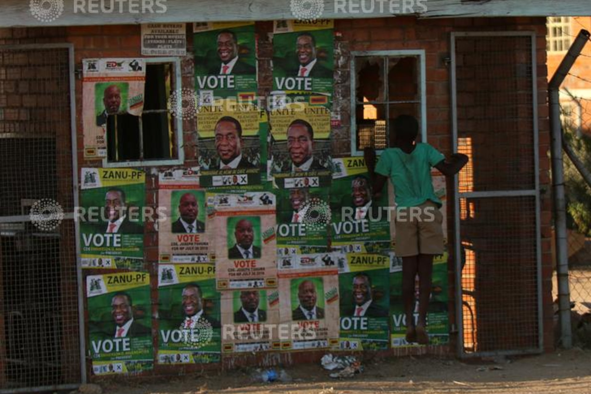 <p>A boy plays next to election posters at White City Stadium where Zimbabwe’s President Emmerson Mnangagwa escaped unhurt after an explosion rocked the stadium, in Bulawayo, Zimbabwe, June 23, 2018. </p>
