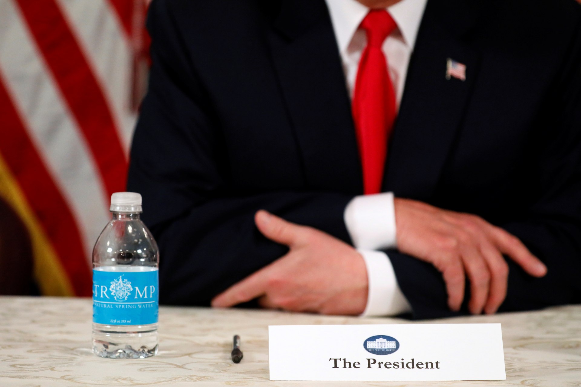 <p>U.S. President Donald Trump, with a bottle of Trump-branded water, speaks to reporters after a security briefing at his golf estate in Bedminster, New Jersey U.S.</p>
