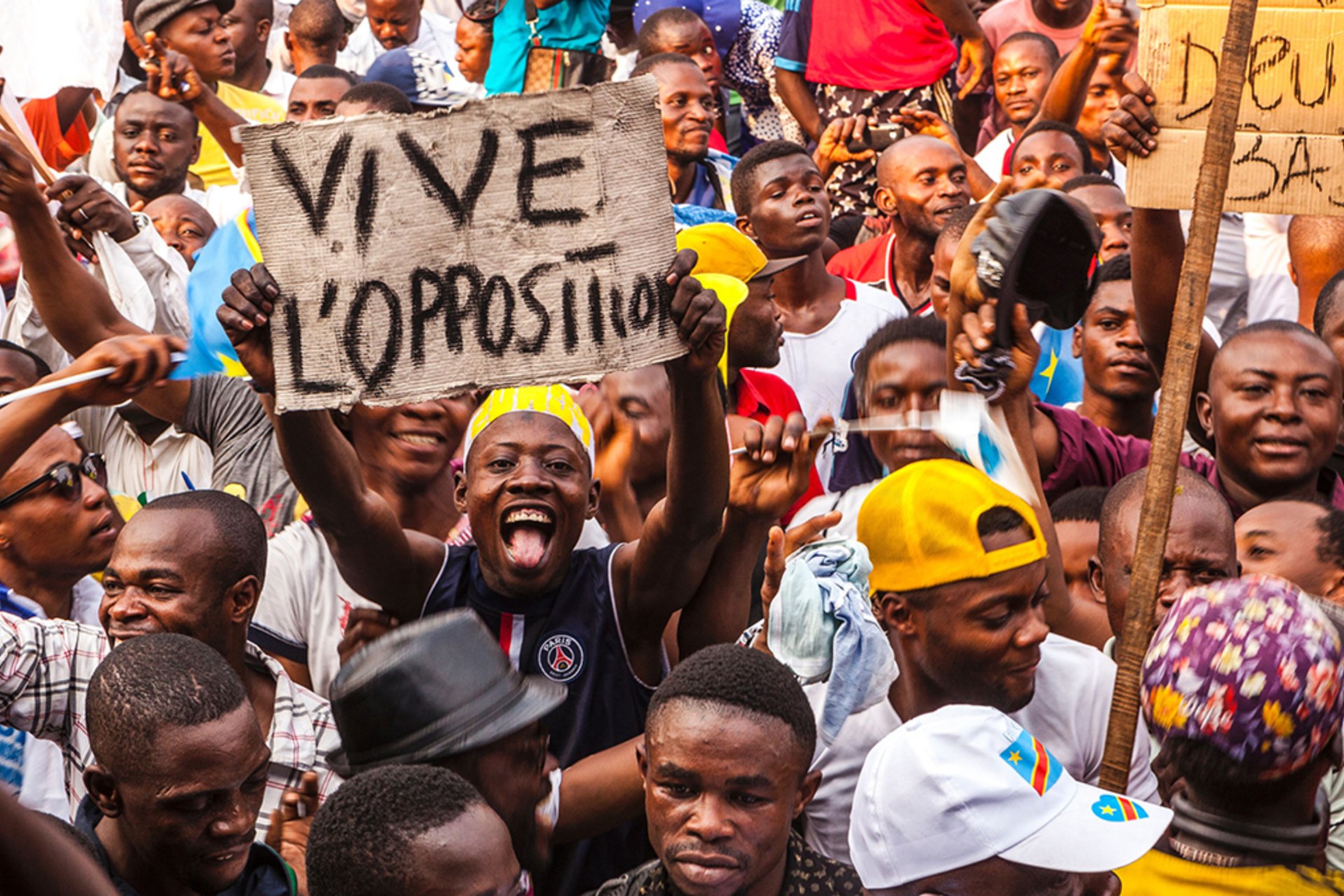 <p>An opposition supporter holds up a reading ‘Long live the opposition’ during a rally organised by political opposition parties in Kinshasa on July 31, 2016.</p>