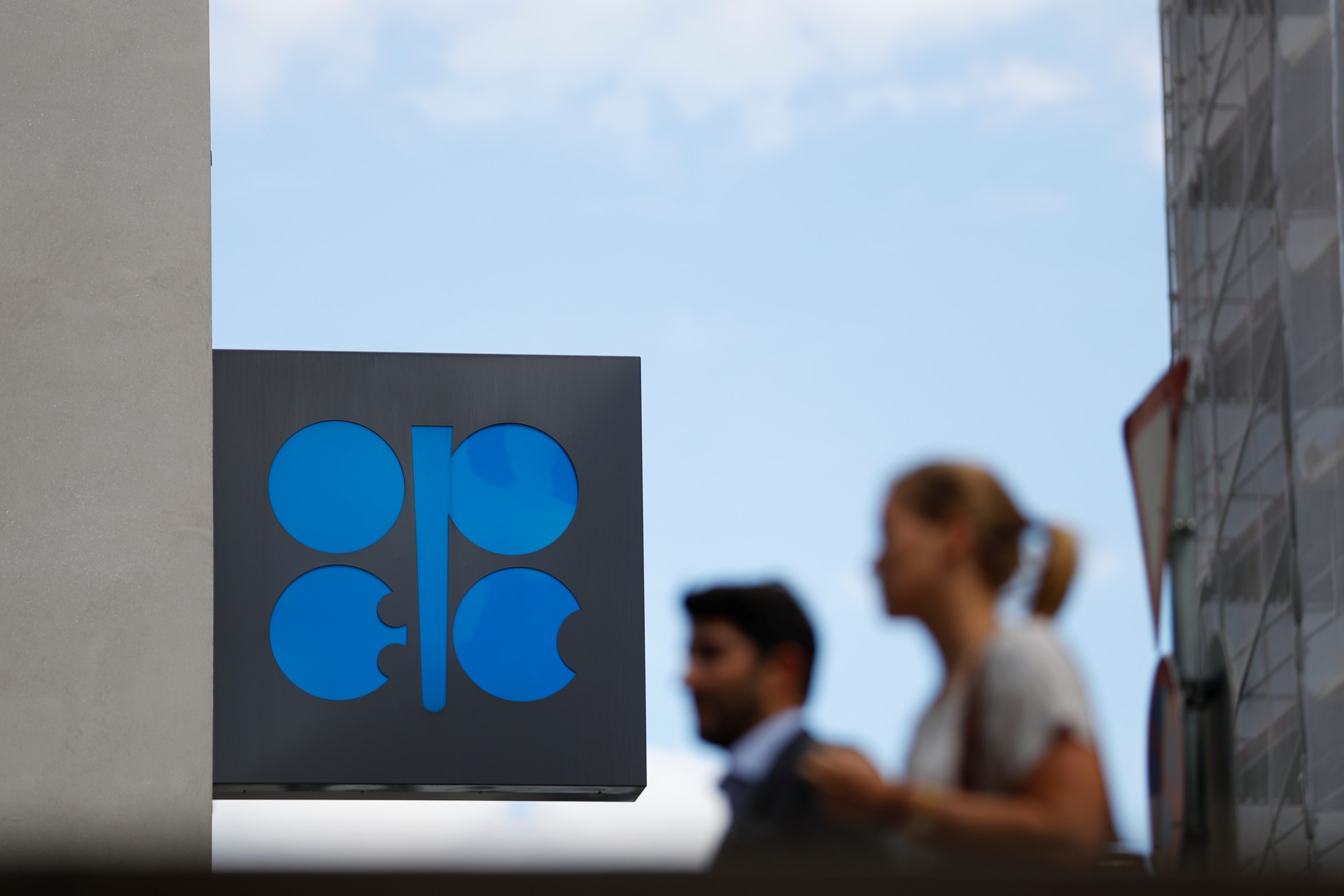 <p>Two persons pass the logo of the Organization of the Petroleoum Exporting Countries (OPEC) in front of OPEC’s headquarters in Vienna, Austria June 19, 2018. </p>