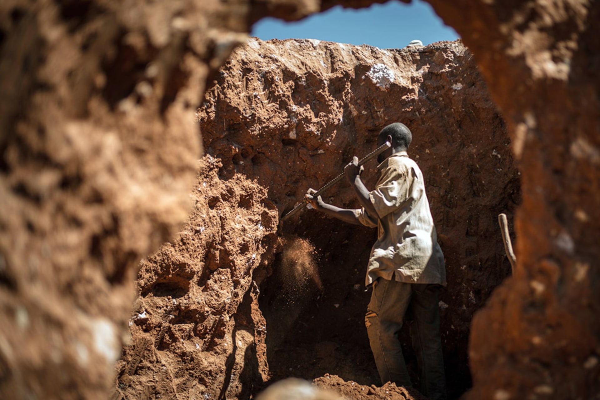 <p>A man digs through some mine waste searching for leftover cobalt.</p>

