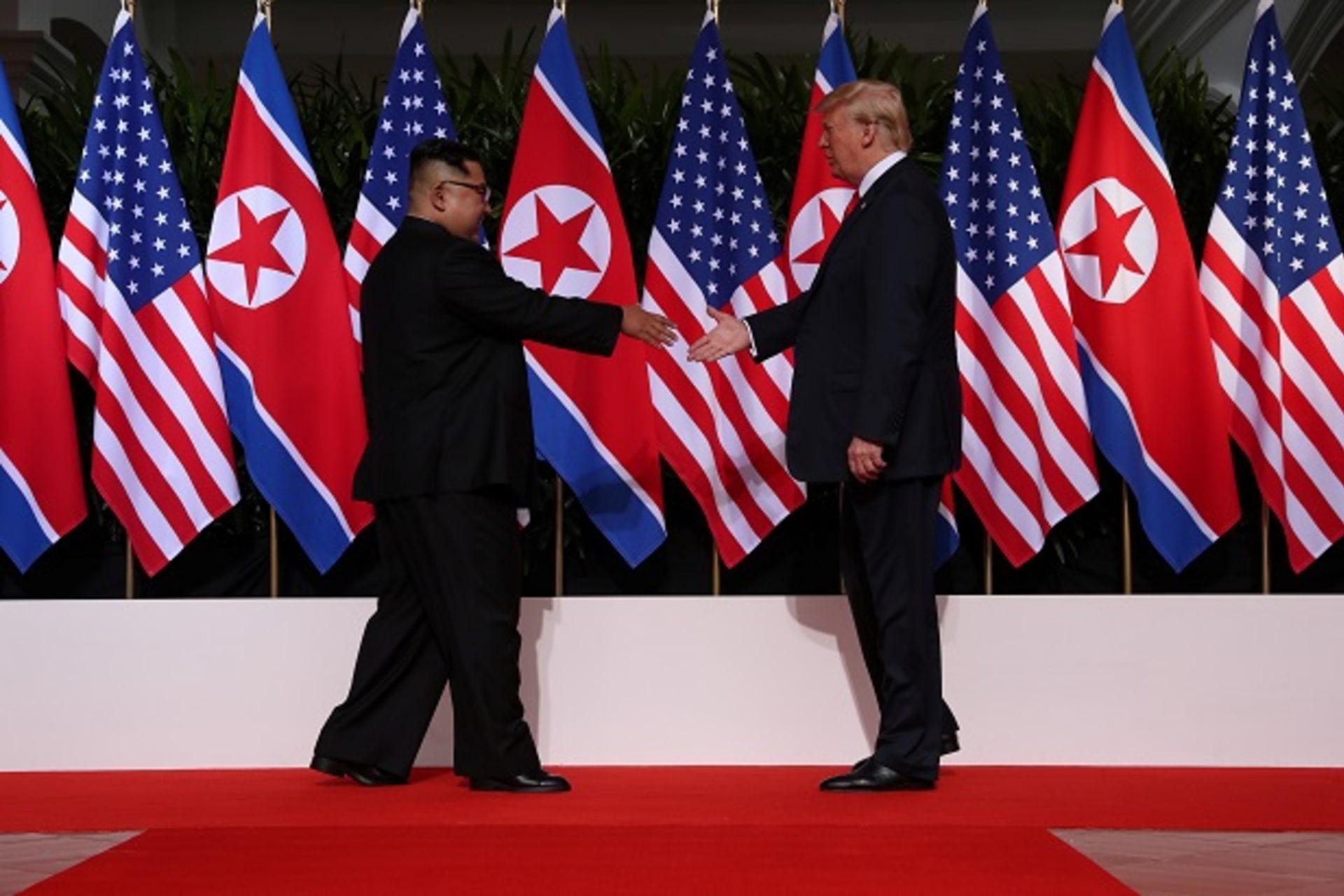 <p>U.S. President Donald Trump shakes hands with North Korean leader Kim Jong Un at the Capella Hotel on Sentosa island in Singapore June 12, 2018.</p>