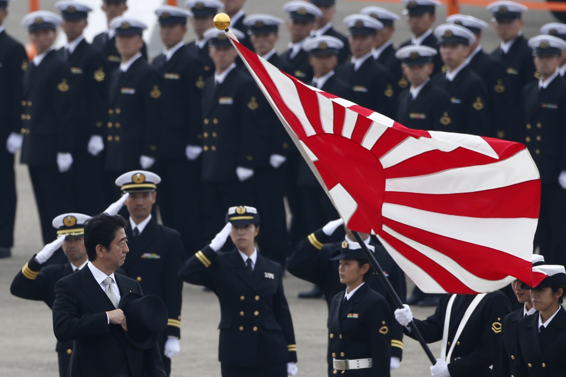 <p>Japan’s Prime Minister Shinzo Abe (L) reviews members of Japan Self-Defense Force (JSDF) during the JSDF Air Review, to celebrate 60 years since the service’s founding at Hyakuri air base in Omitama on October 26, 2014.</p>
