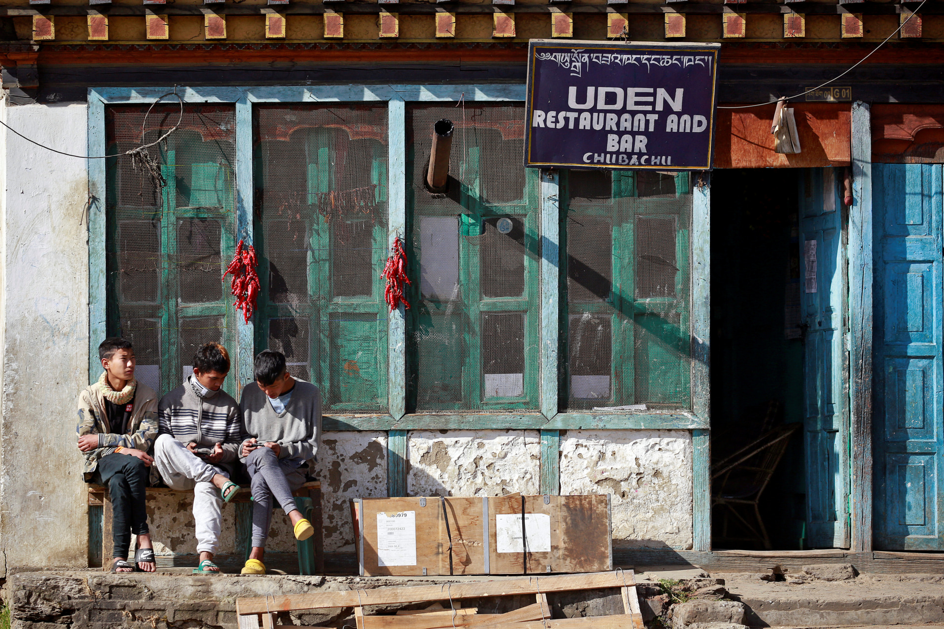 <p>Youths sit outside a restaurant in the capital city of Thimphu, Bhutan on December 16, 2017.</p>
