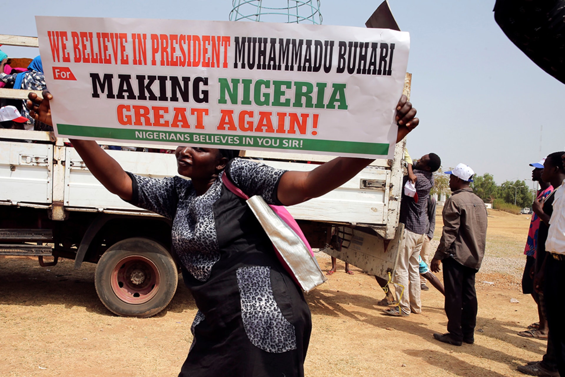 <p>A woman holds a placard during a rally in Abuja, Nigeria, to show support for President Muhammadu Buhari. </p>
