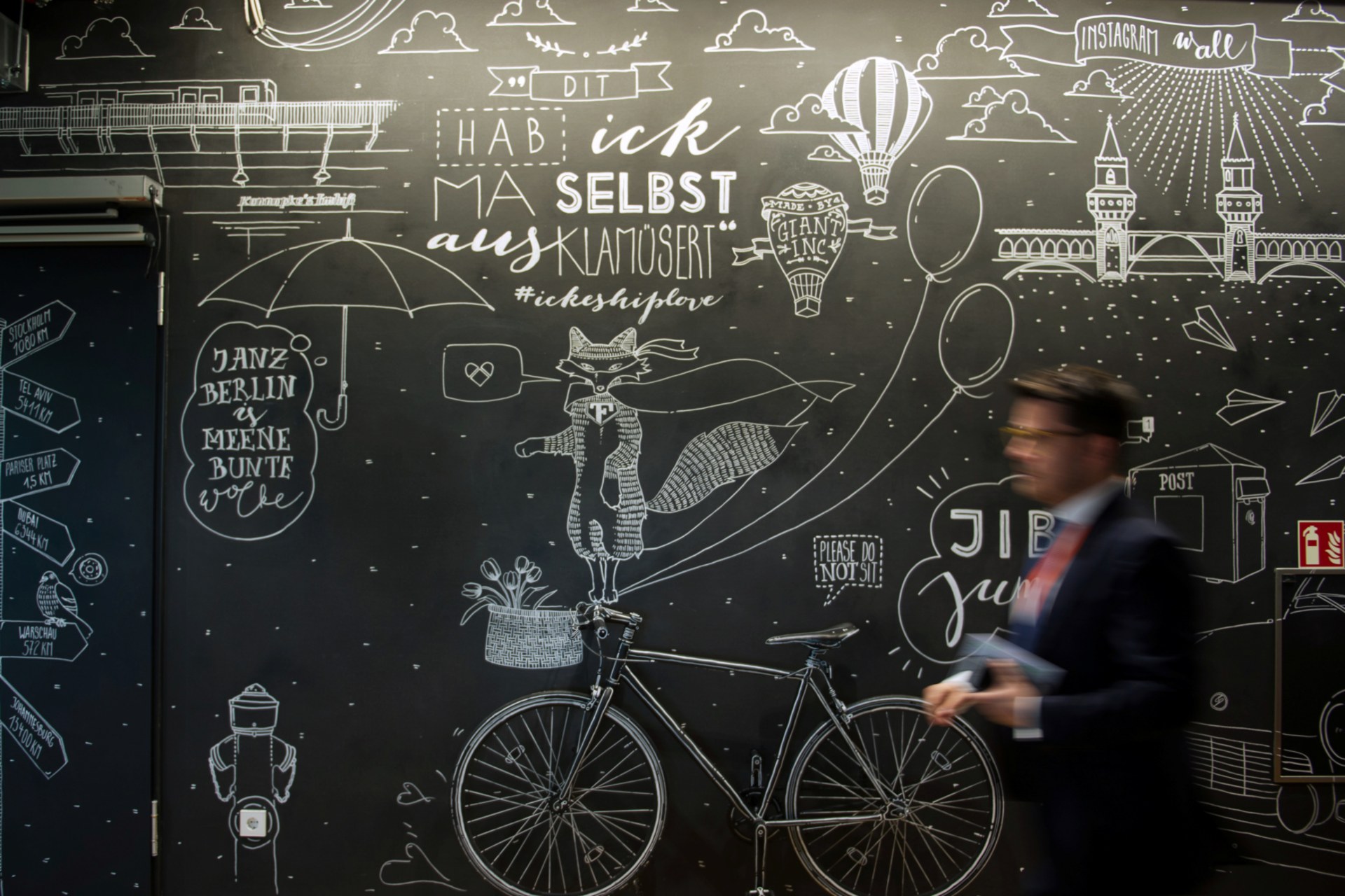 <p>A man walks in front of a mural at the Facebook office in Berlin on August 29, 2016.</p>
